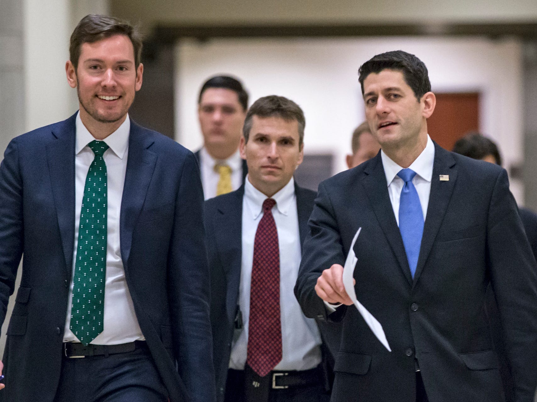 House Speaker Paul Ryan of Wis., center, walks with his chief communications adviser Brendan Buck, left, on the way to meet with reporters on Capitol Hill in Washington, Thursday, Feb. 4, 2016.