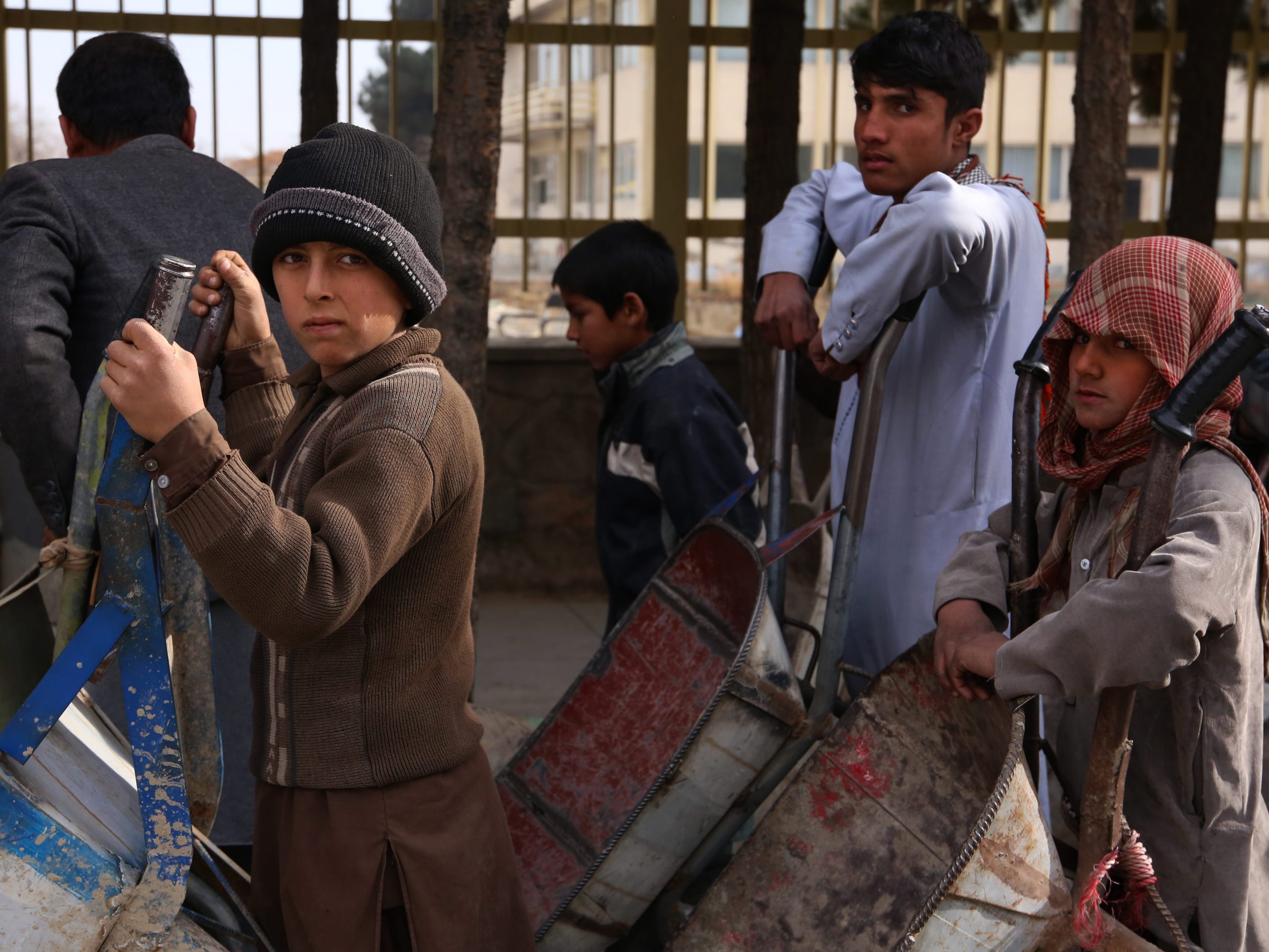 Afghans wait in food aid line.