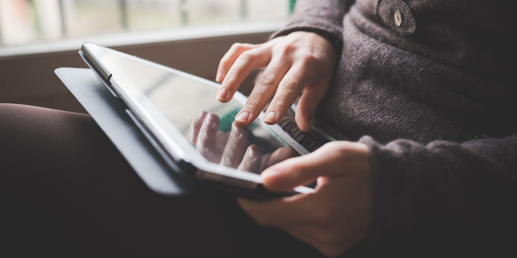 woman holding ipad