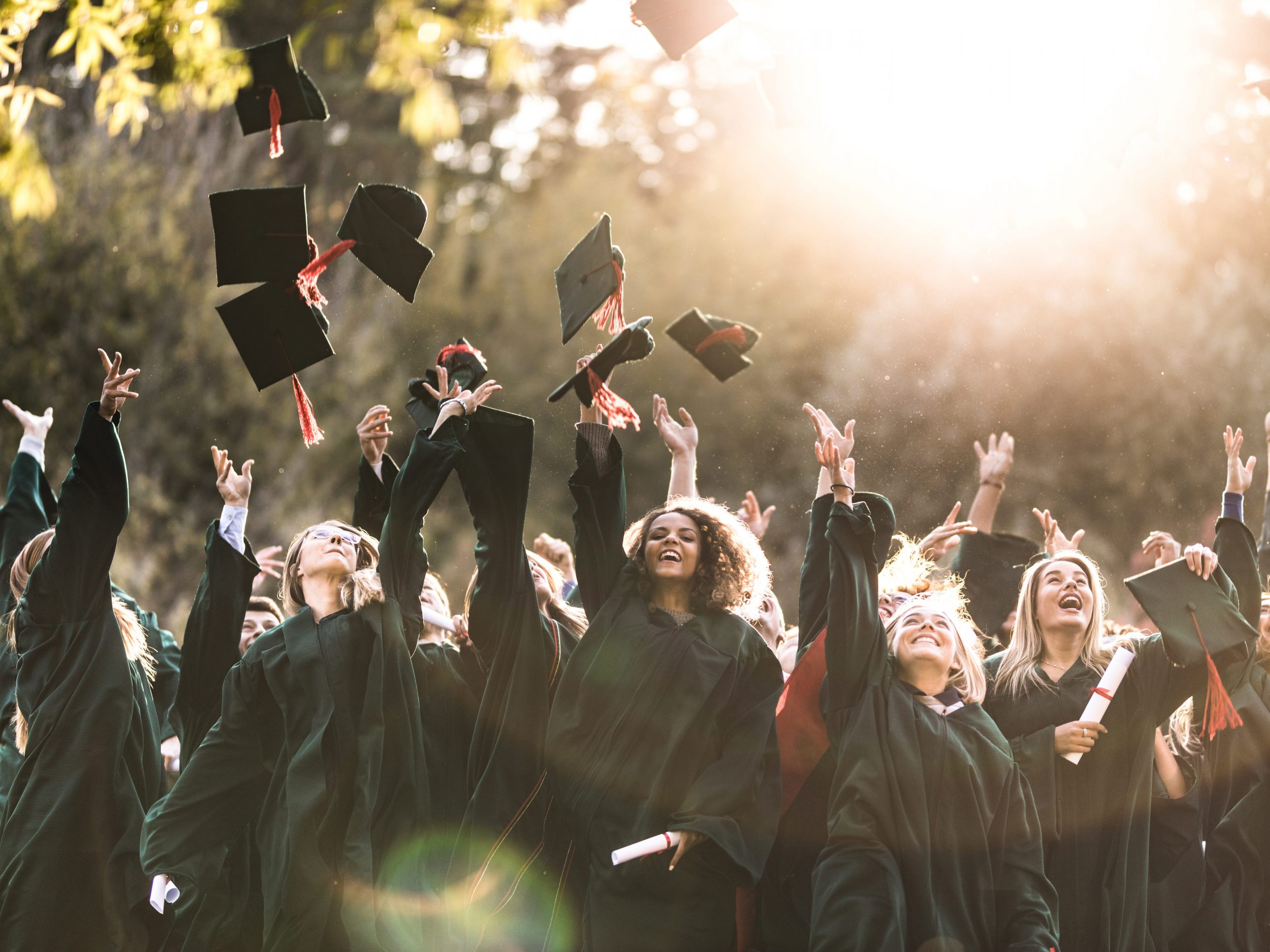 College graduates throwing caps