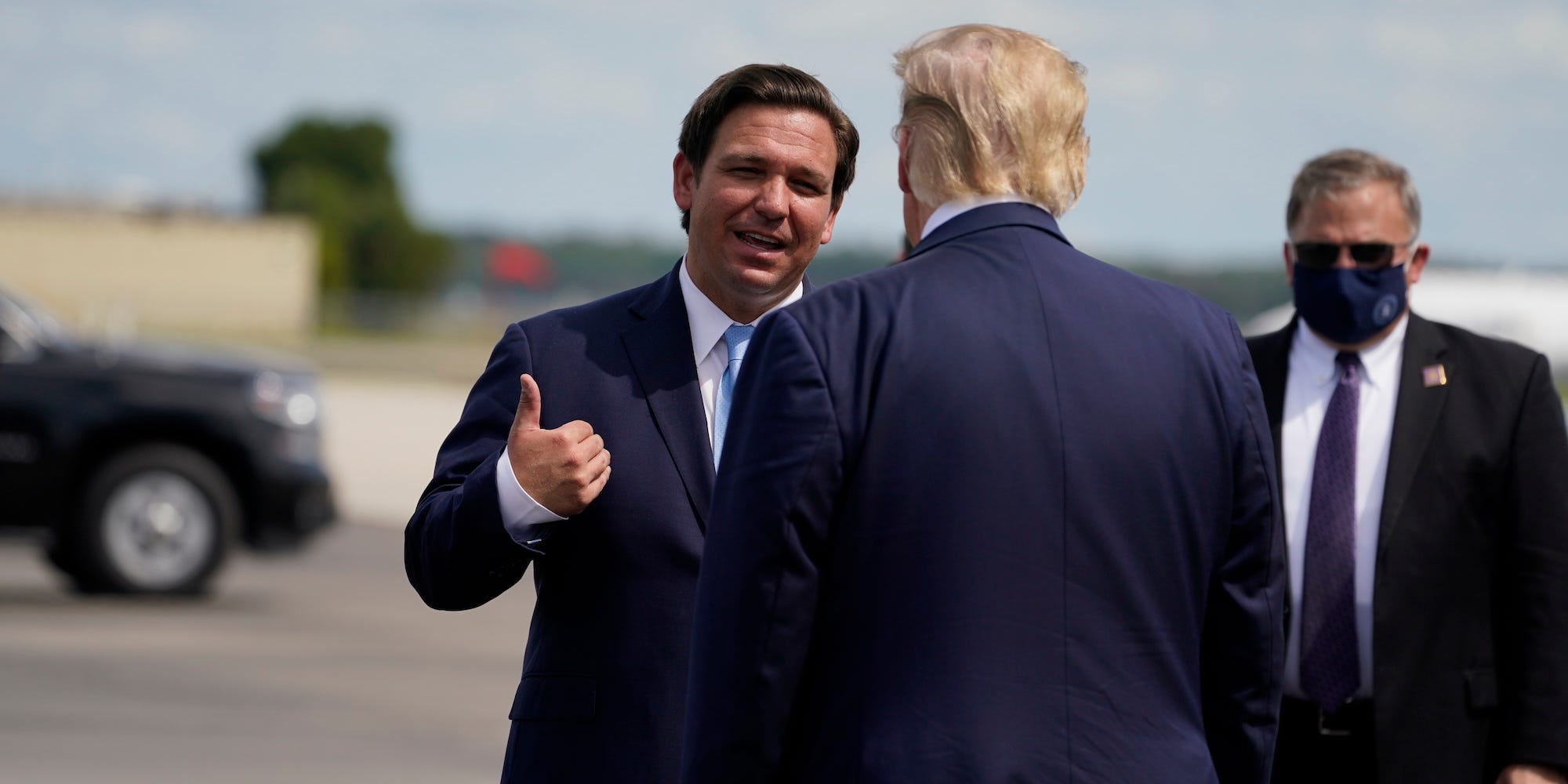 President Donald Trump speaks with Florida Gov. Ron DeSantis as he arrives at Southwest Florida International Airport, Friday, Oct. 16, 2020, in Fort Myers, Fla.