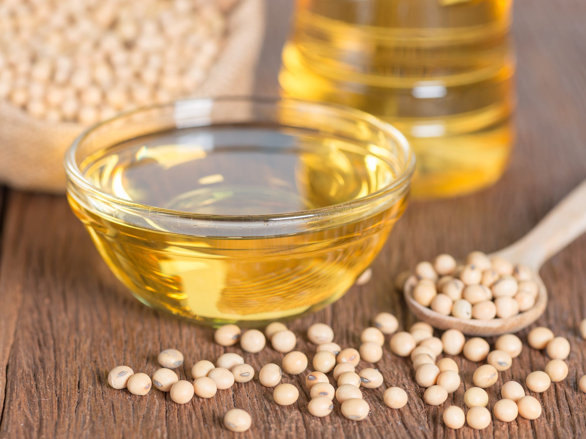 soybean oil with soybeans on a wooden table