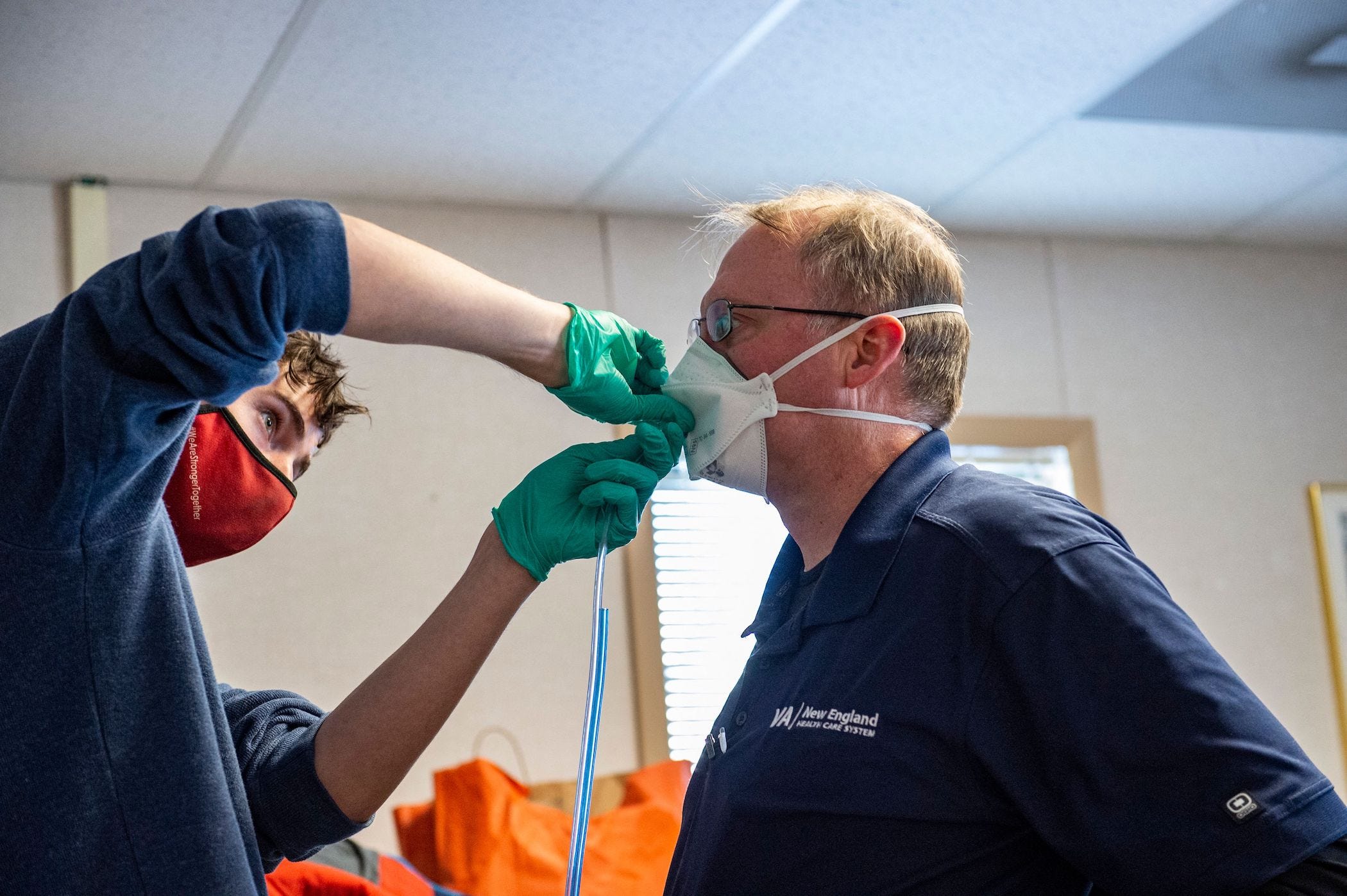 A medical worker fit tests an N95 mask to a hospital worker at the US Department of Veterans Affairs Boston in West Roxbury, Massachusetts on January 11, 2022.