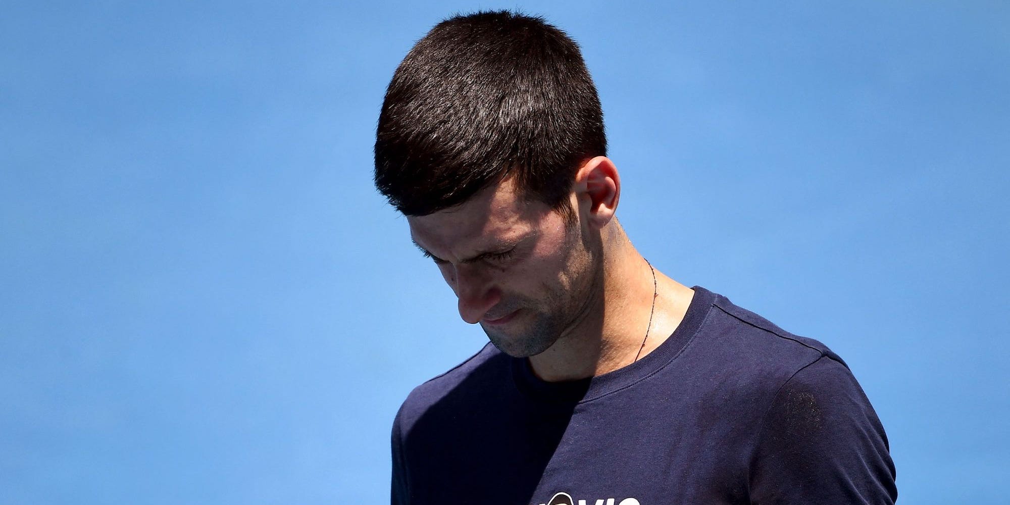 Novak Djokovic of Serbia looks at his racquet during a practice session ahead of the Australian Open at the Melbourne Park tennis centre in Melbourne