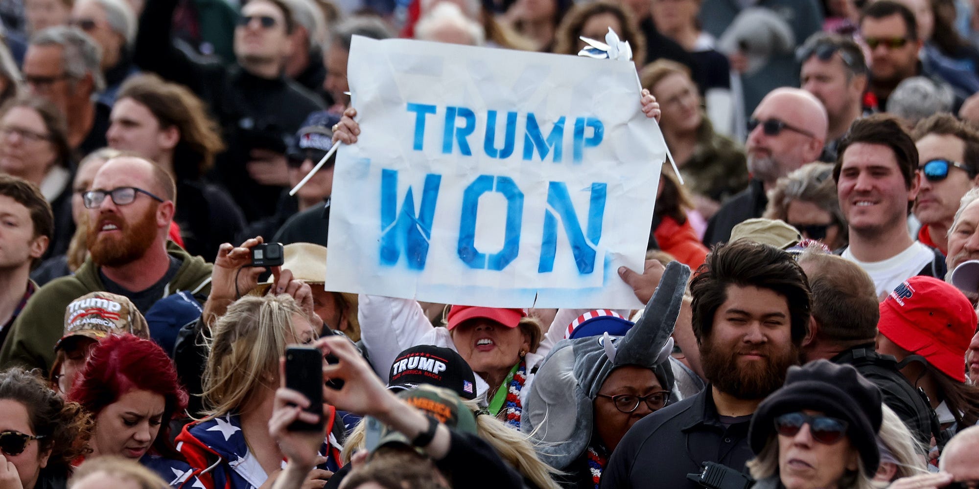 A supporter holds a 'Trump Won' sign at a rally by former President Donald Trump at the Canyon Moon Ranch festival grounds on January 15, 2022 in Florence, Arizona.