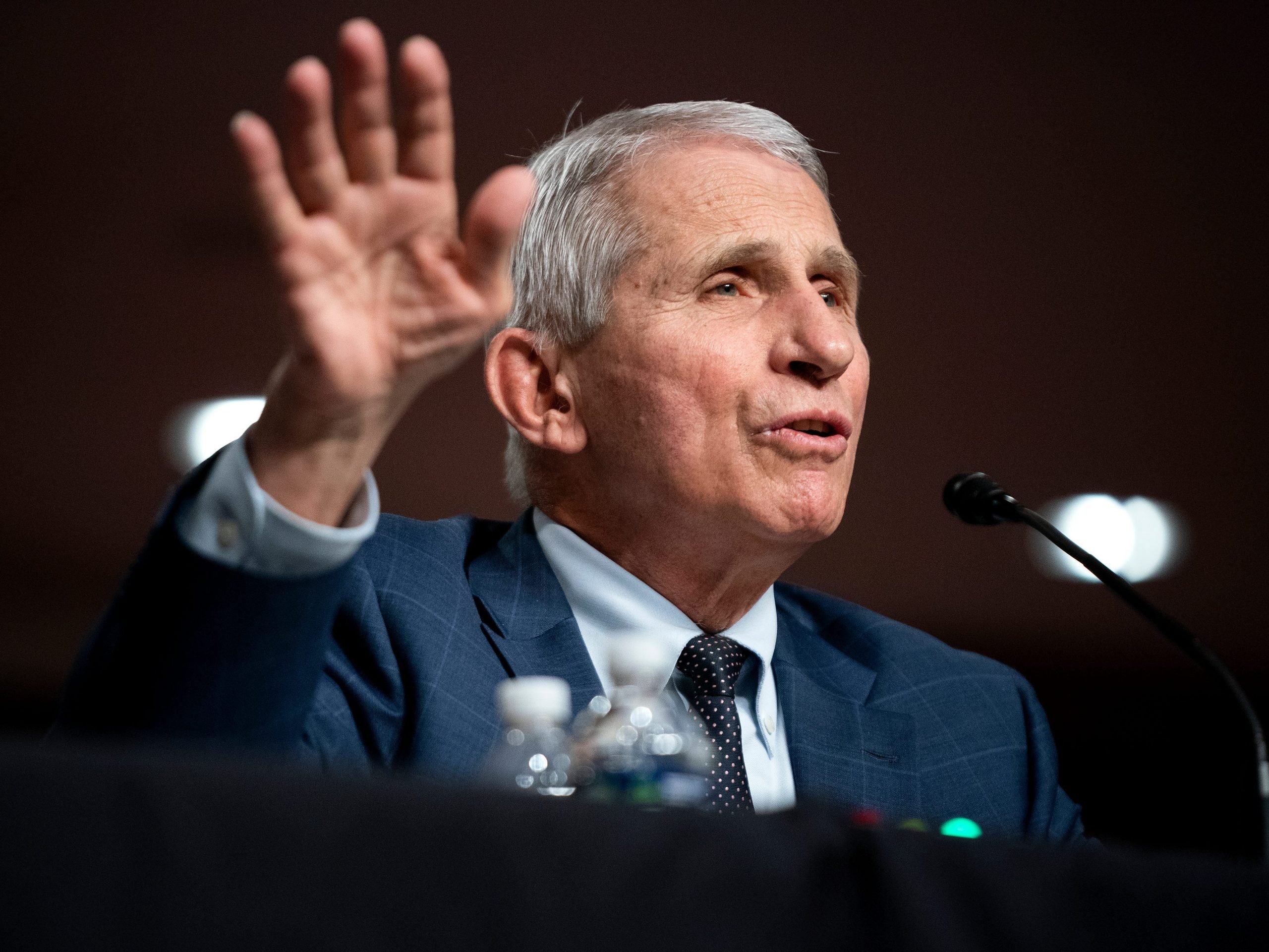 Dr. Anthony Fauci raises right hand as he testifies at a Senate Health, Education, Labor, and Pensions Committee hearing on Capitol Hill.