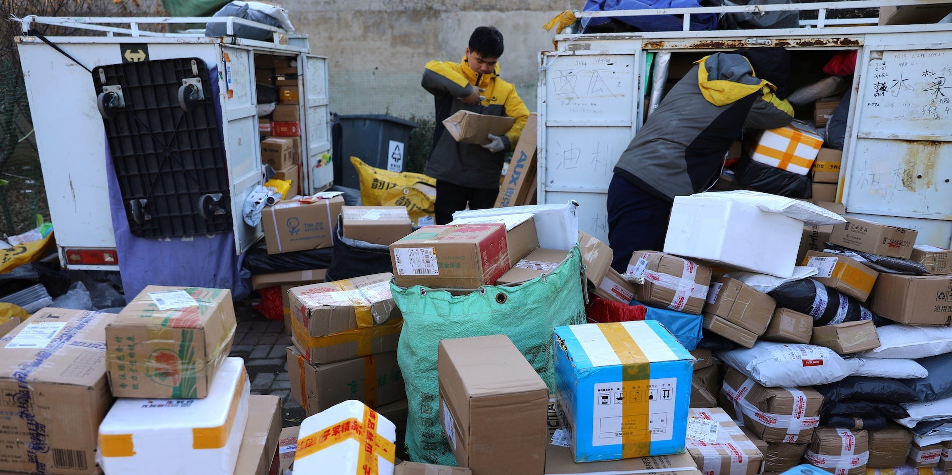 Delivery workers sort parcels at a makeshift logistics station during Singles’ Day shopping festival in Beijing, China November 11, 2021.