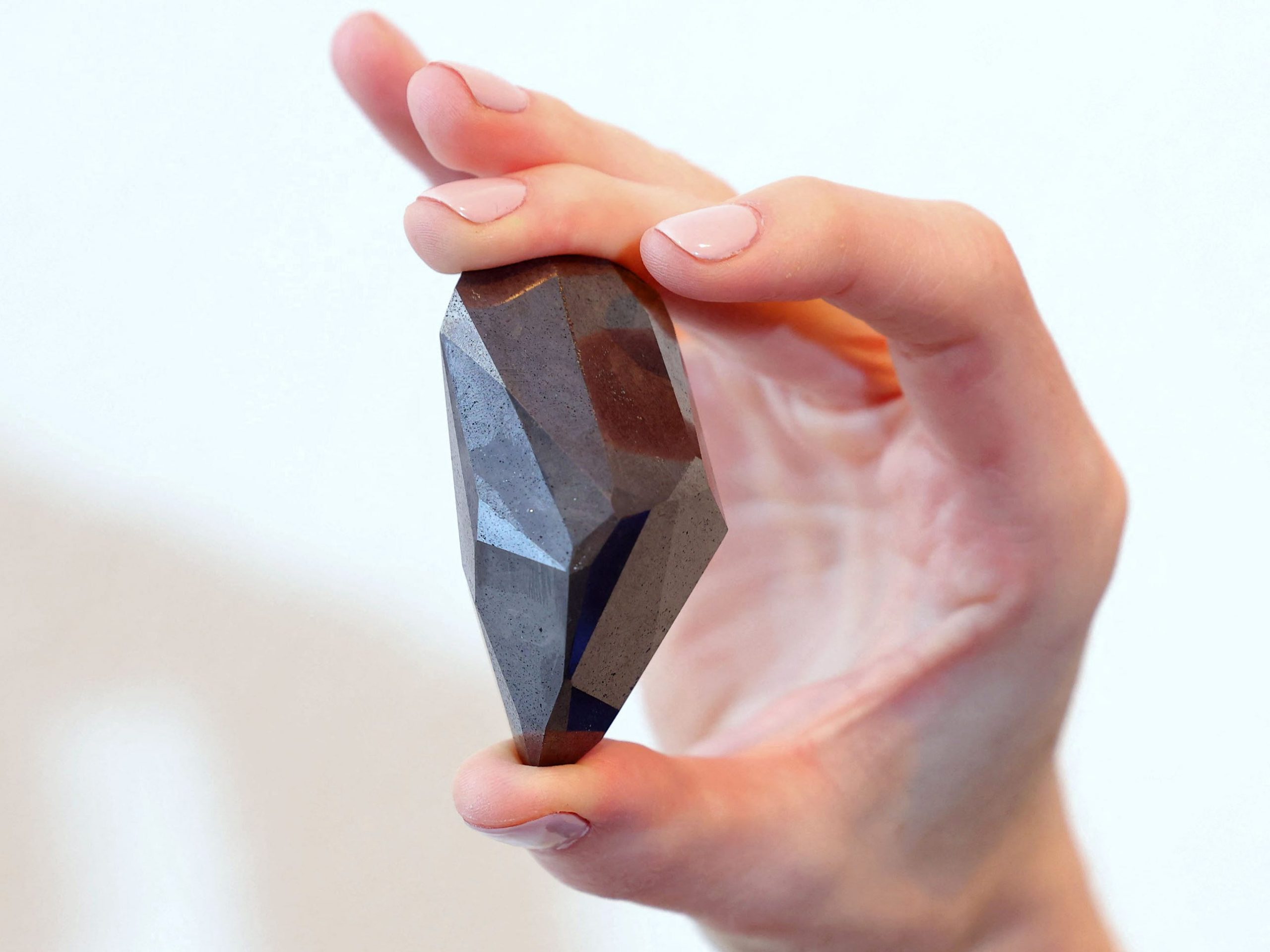 A picture taken on January 17, 2022 shows "The Enigma", a 555.55 carat black diamond, at Sotheby's in the Gulf emirate of Dubai.