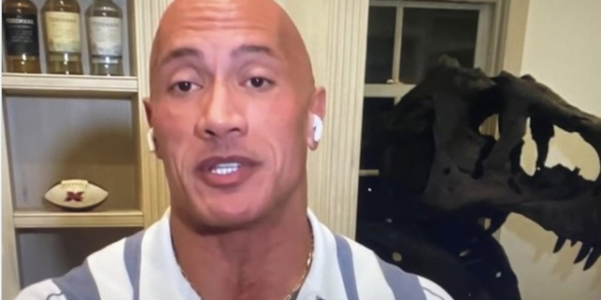 The Rock and the skull of a t-rex at his house