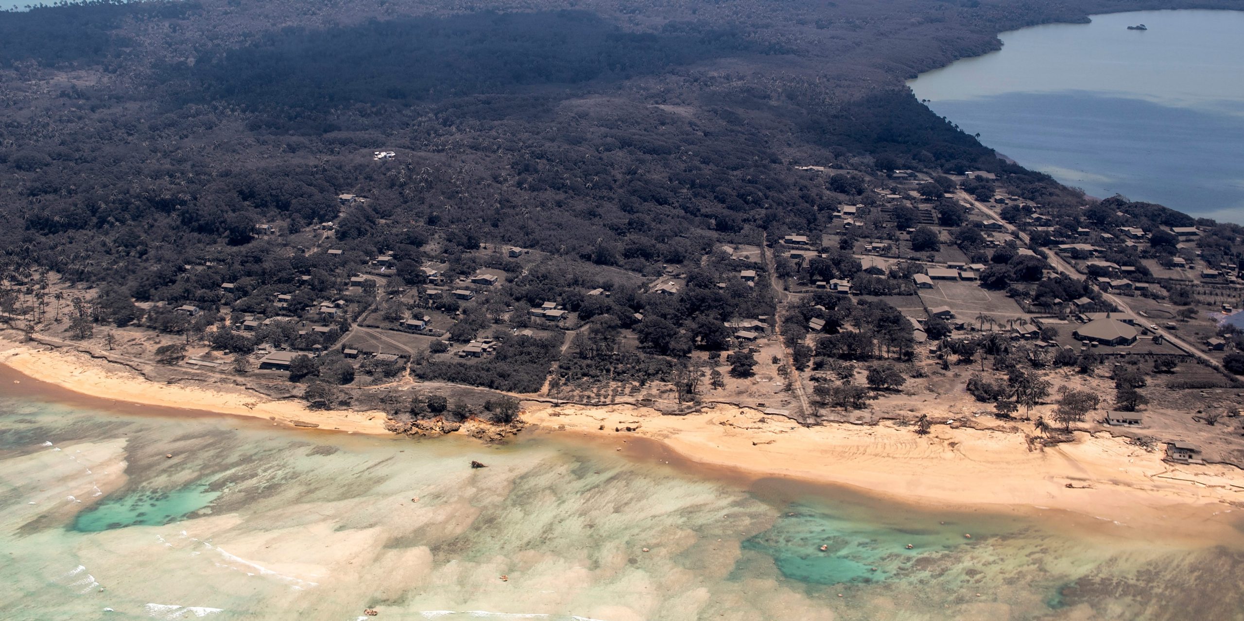 Volcanic ash covers roof tops and vegetation in an area of Tonga on January 17, 2022.
