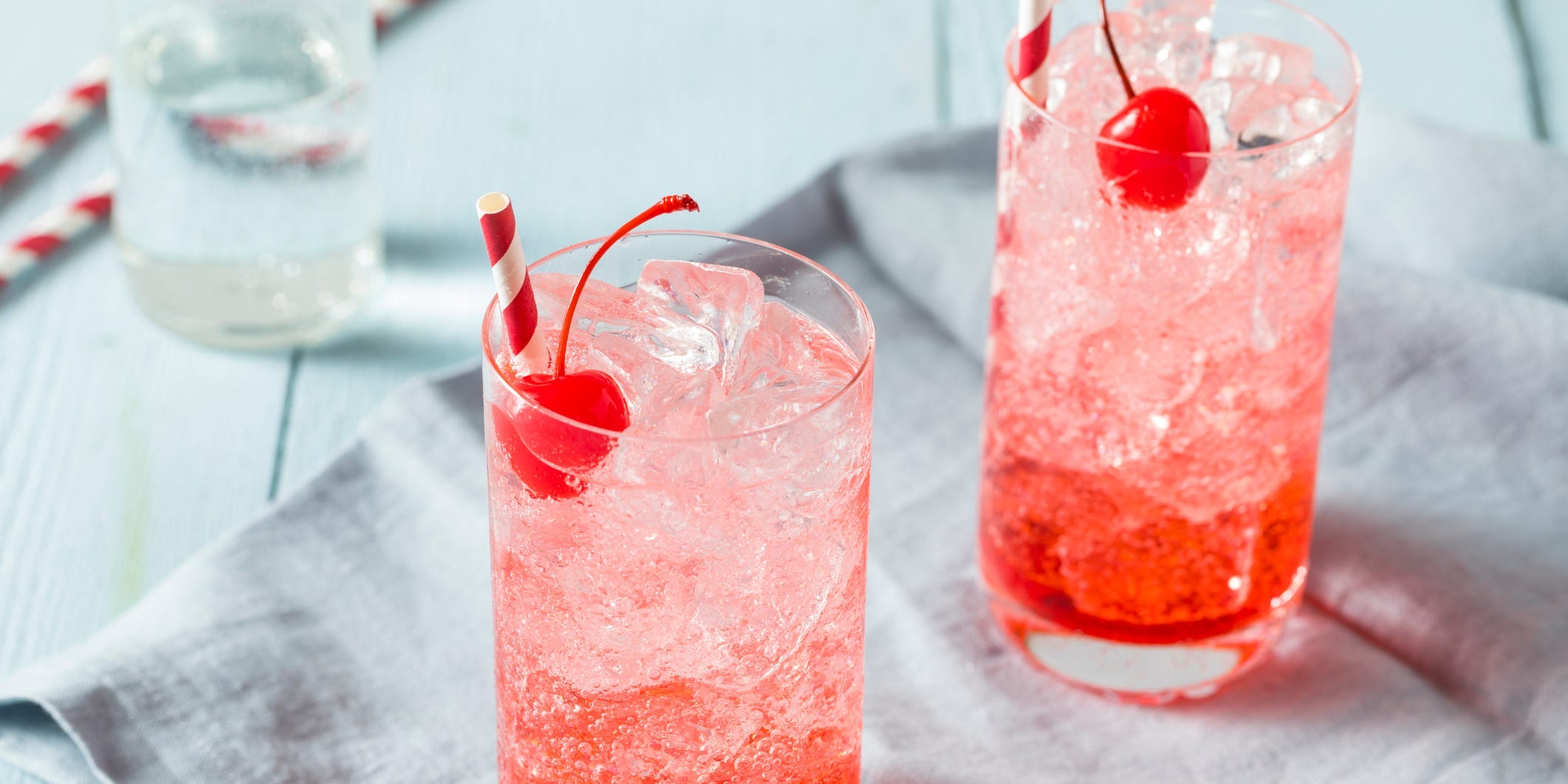 Two Shirley Temple mocktails garnished with cherries