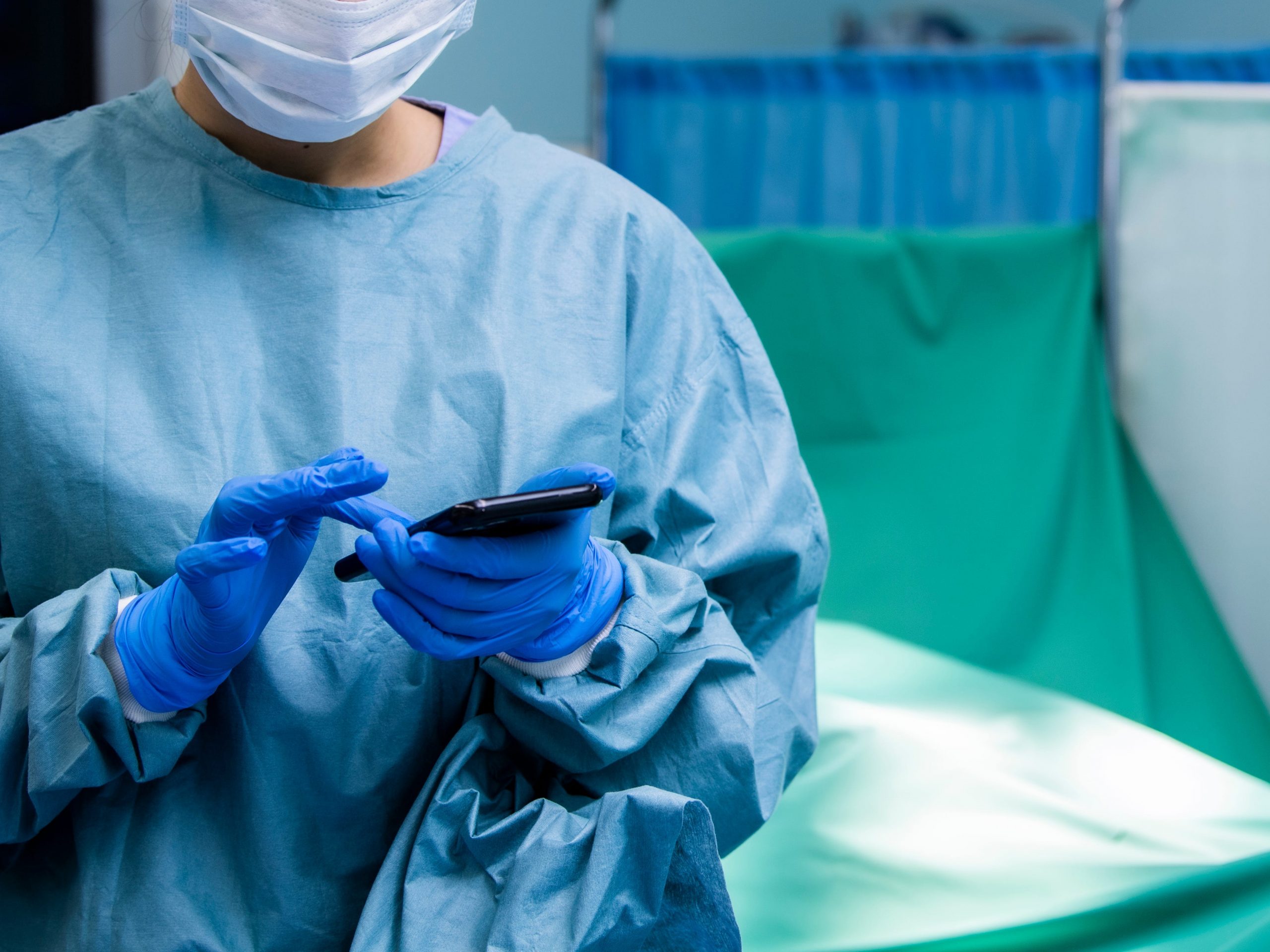 doctor using a smartphone in the operating room