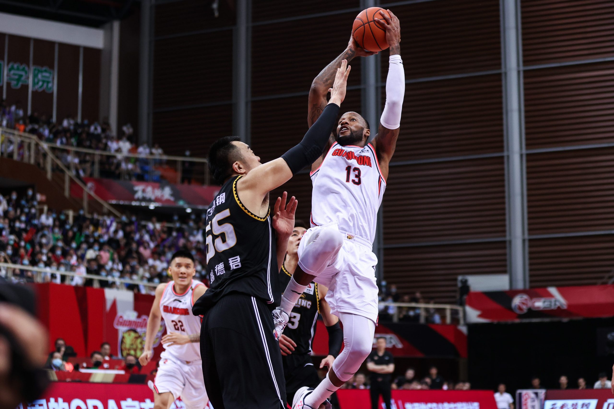 Sonny Weems leaps into the air for a shot as his opponent attempts to guard him.