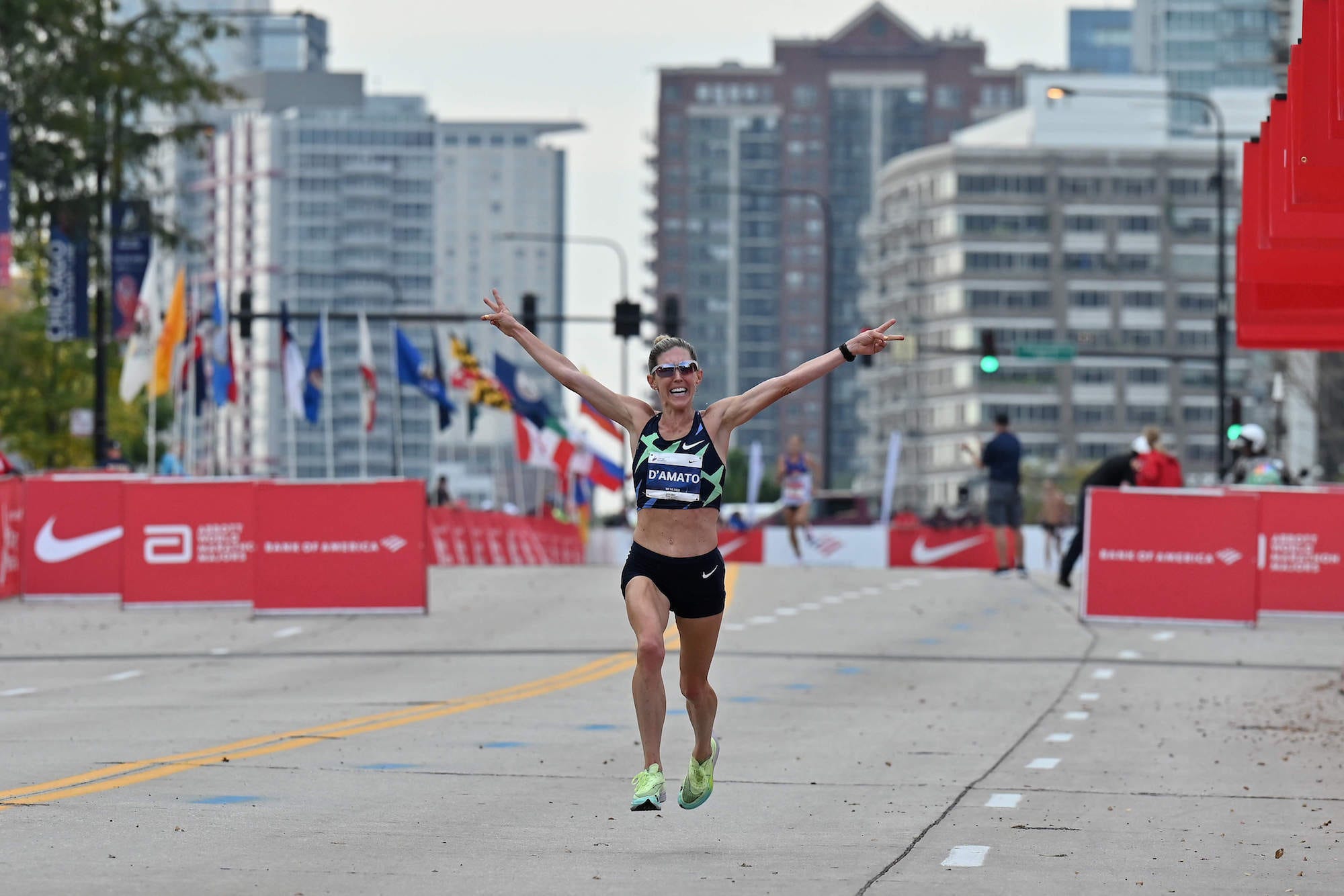 Keira D'Amato of the United States begins to celebrates as she approaches the finish line during the 2021 Chicago Marathon on October 10, 2021 in Chicago, Illinois. D'Amato finished fourth in the women's field