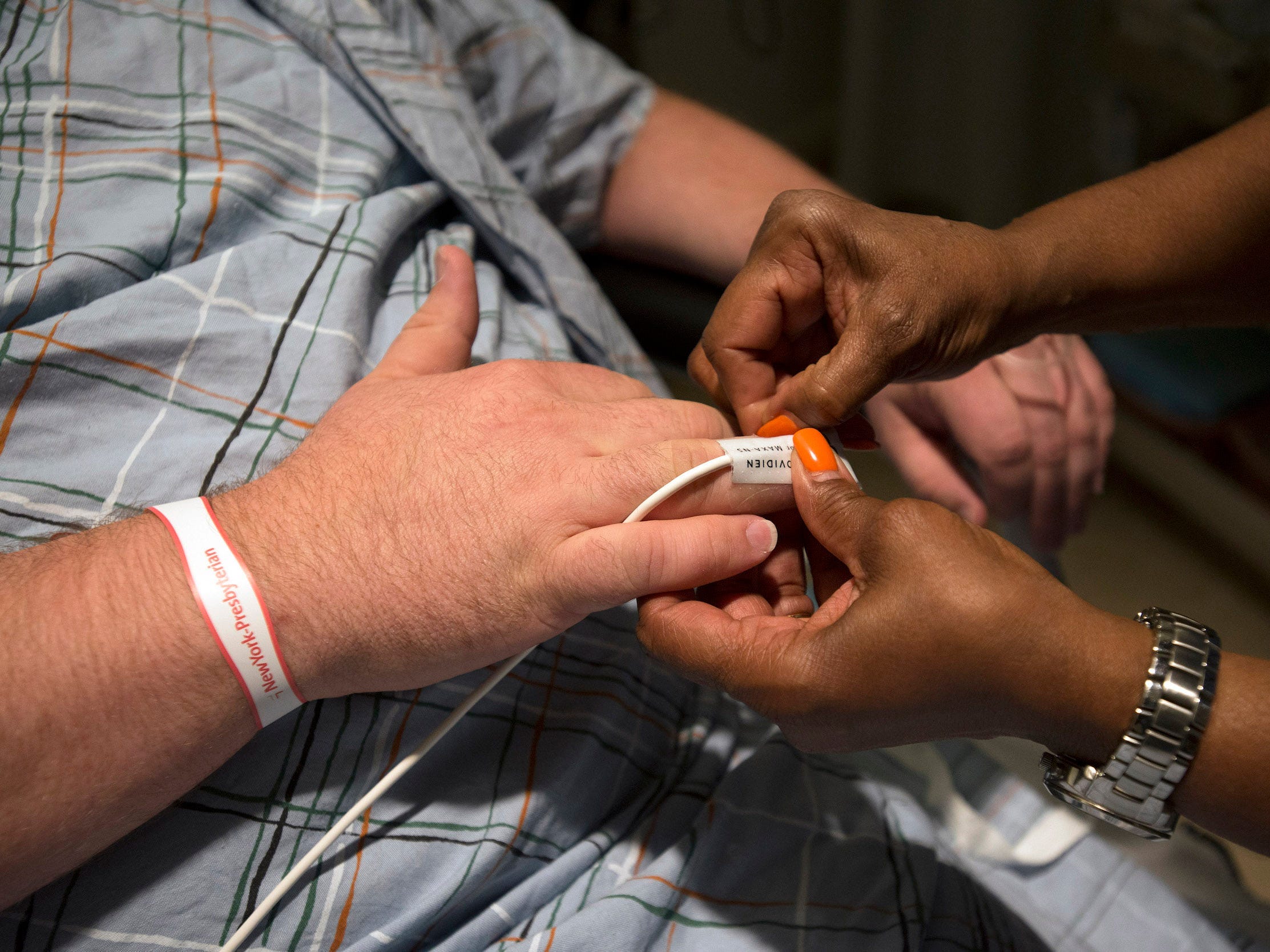 nurse hands give patient hand an iv