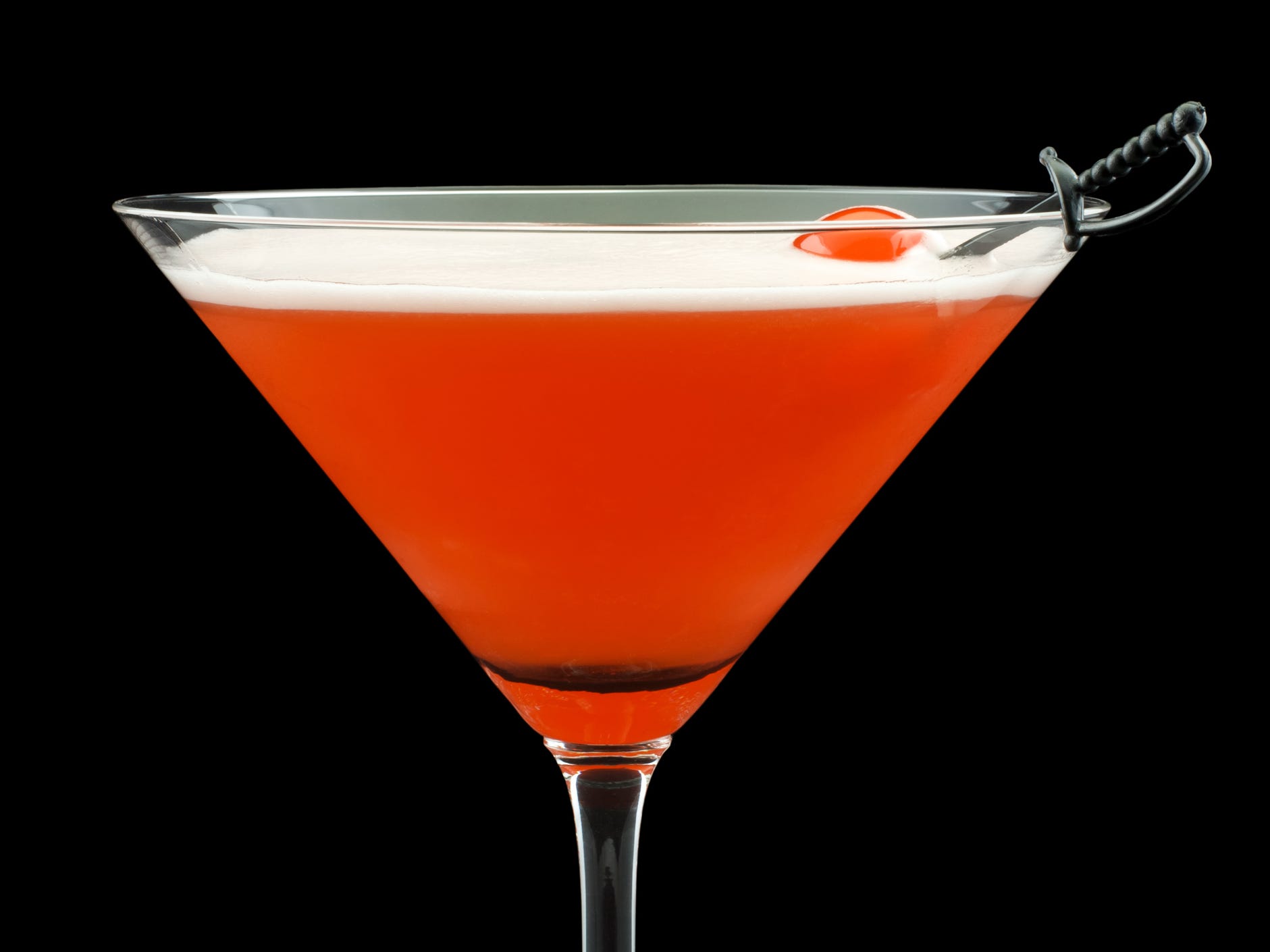 A Mary Pickford cocktail in a martini glass against a black background