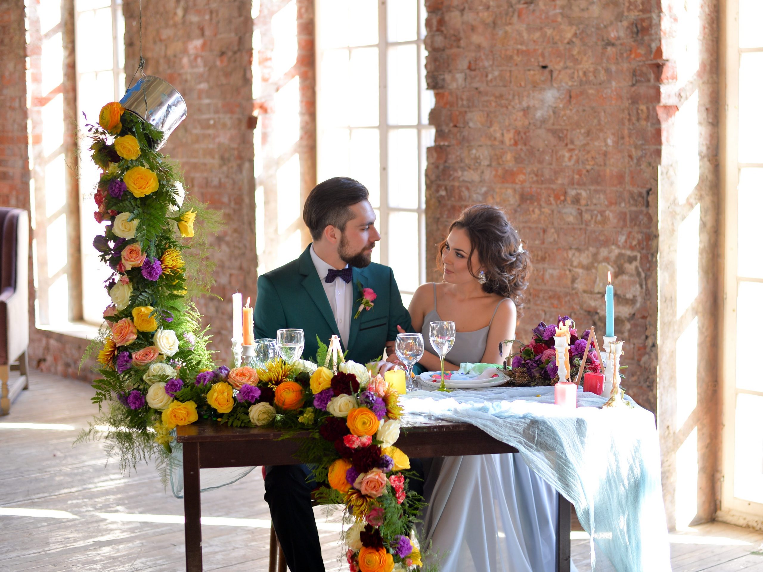 A couple sits alone at a private table with floral decor on it.