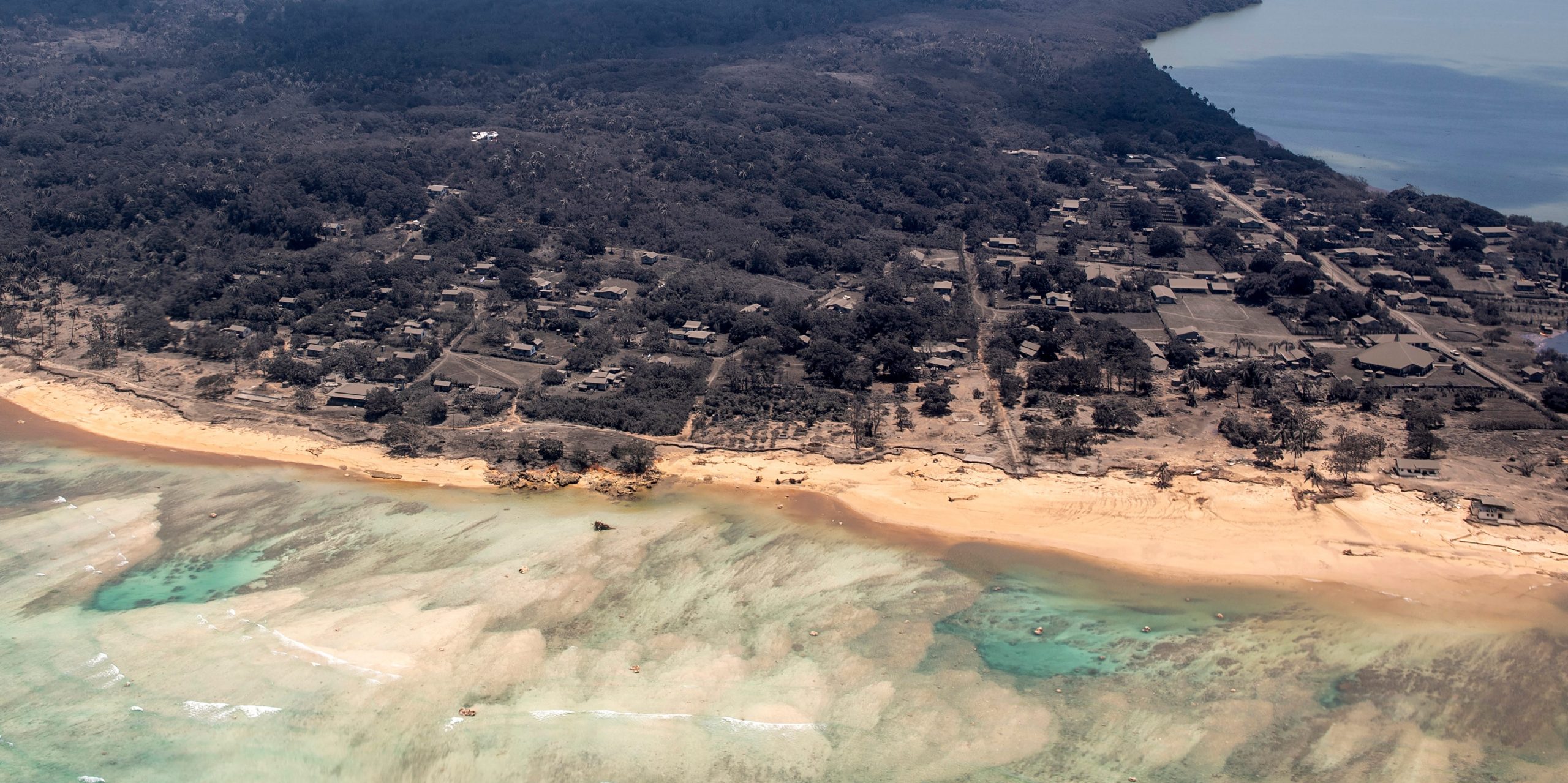 Volcanic ash covers roof tops and vegetation in an area of Tonga on January 17, 2022.