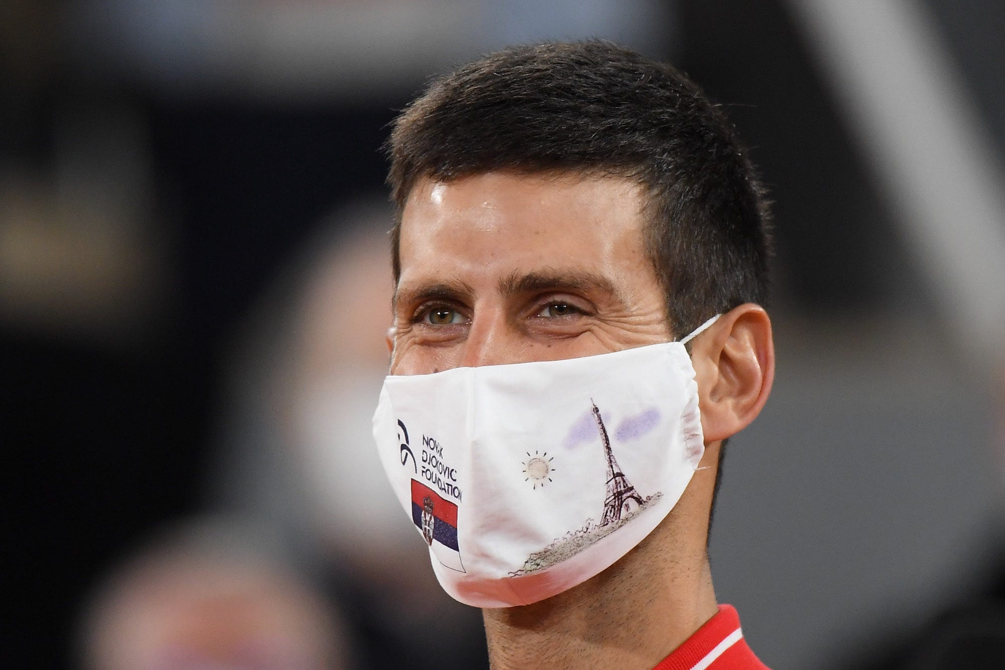 Finalist Novak Djokovic of Serbia, wearing a protective face mask with the drawing of the Eiffel Tower during the trophy ceremony of the Men's Final on day 15 of the 2020 French Open on Court Philippe Chatrier at Roland Garros stadium