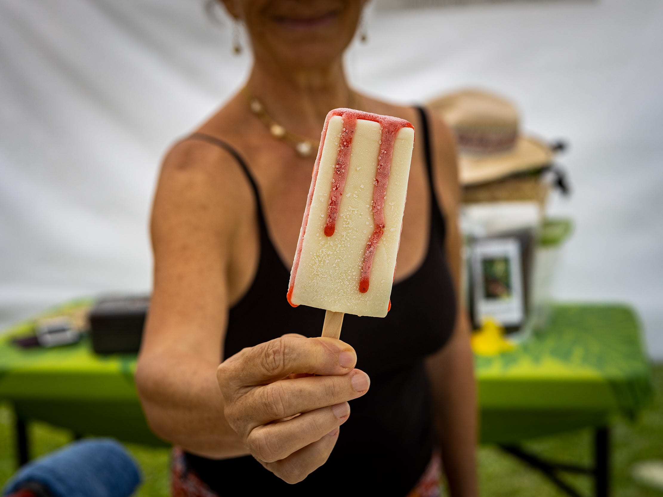 A woman holding a popsicle.