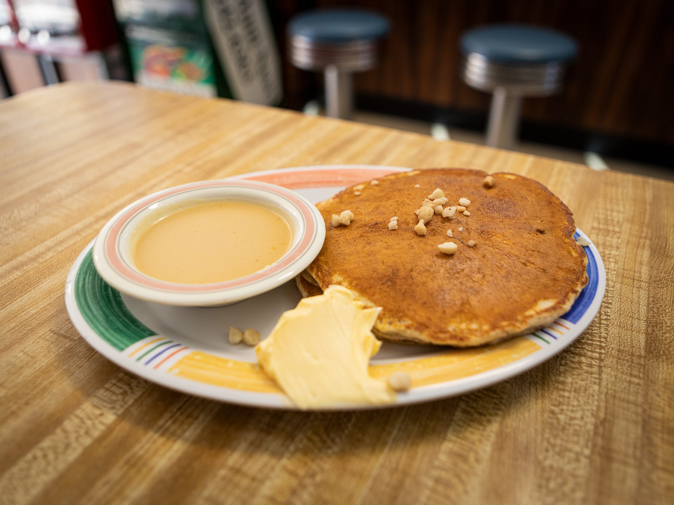 A plat of pancakes on a table.