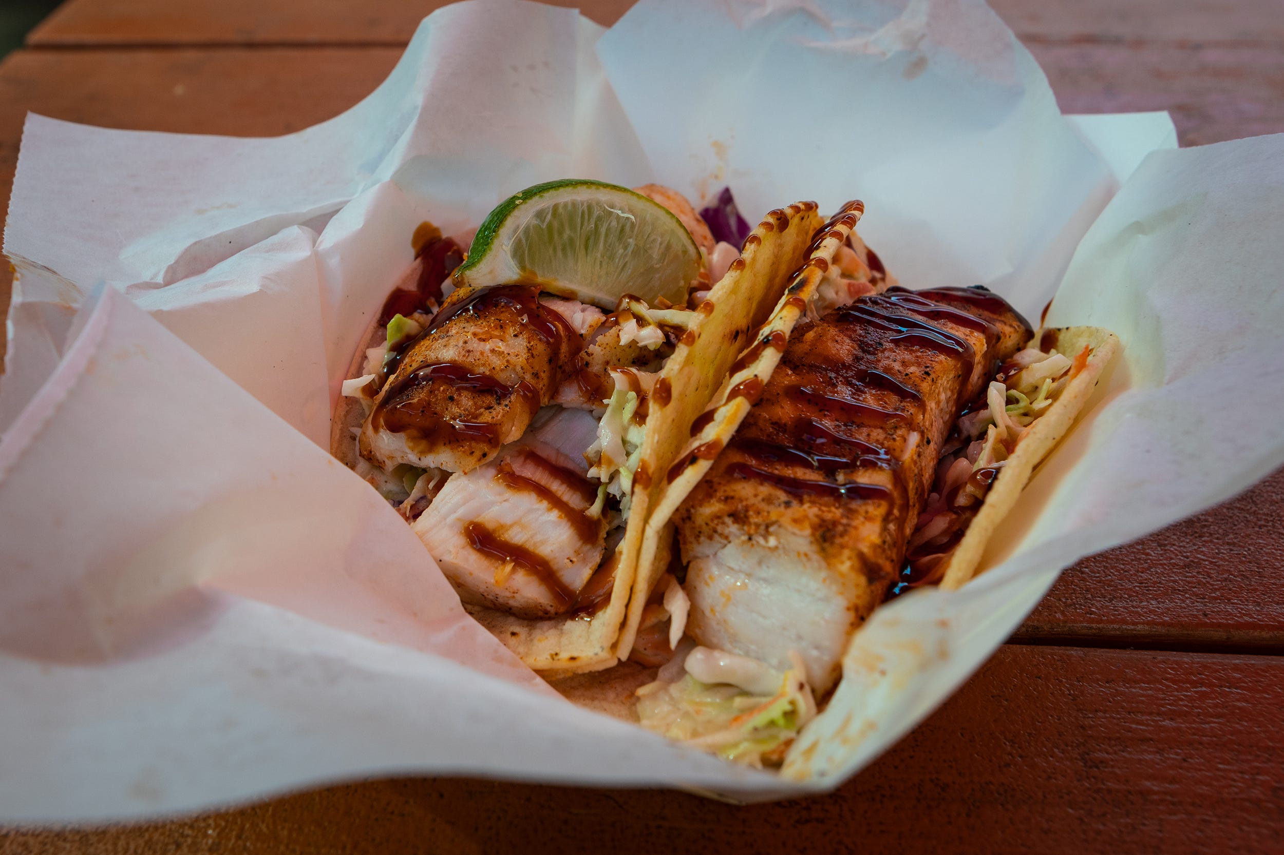 A dish of two fish tacos.