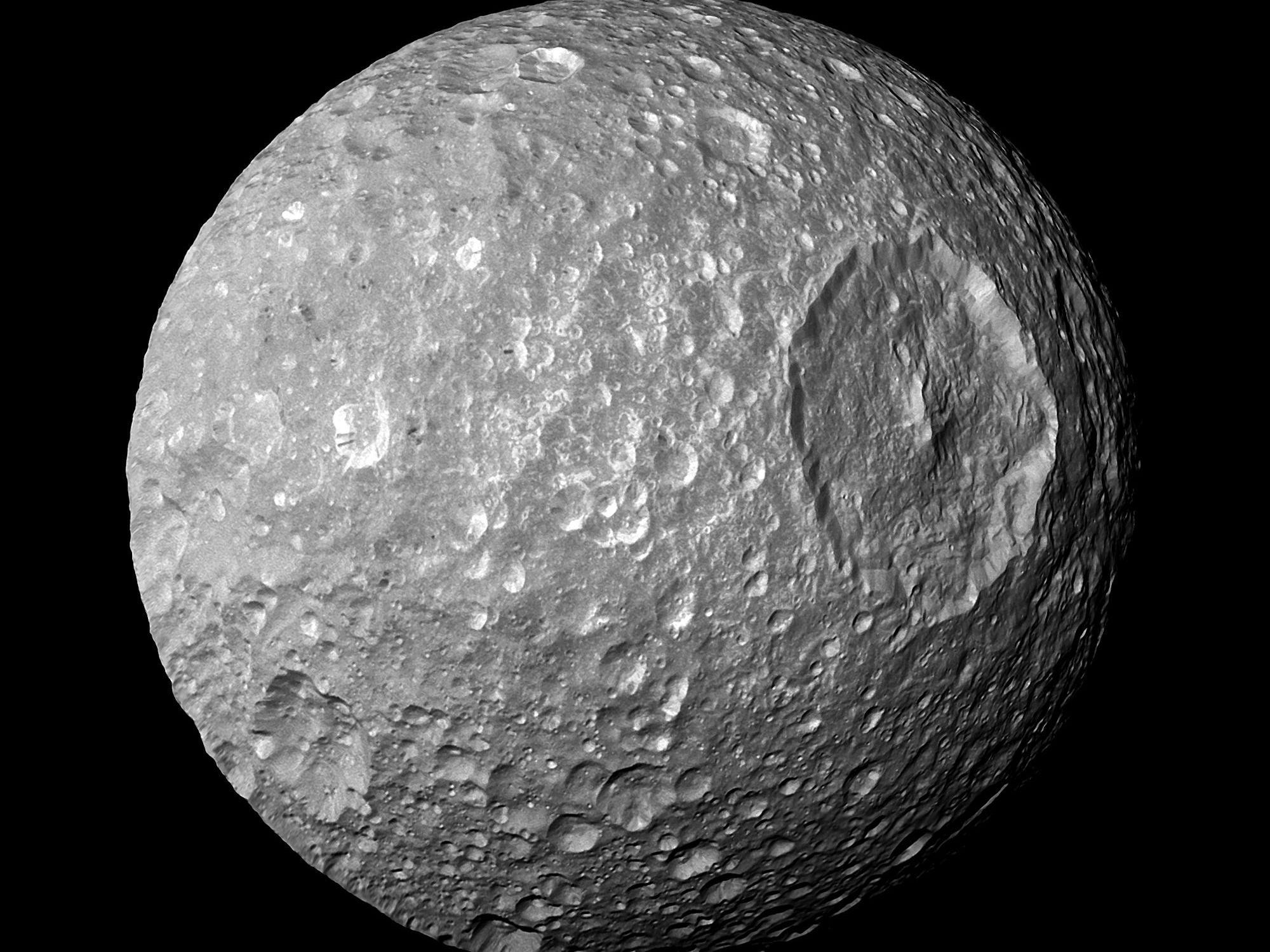 mimas moon round grey rock with large crater