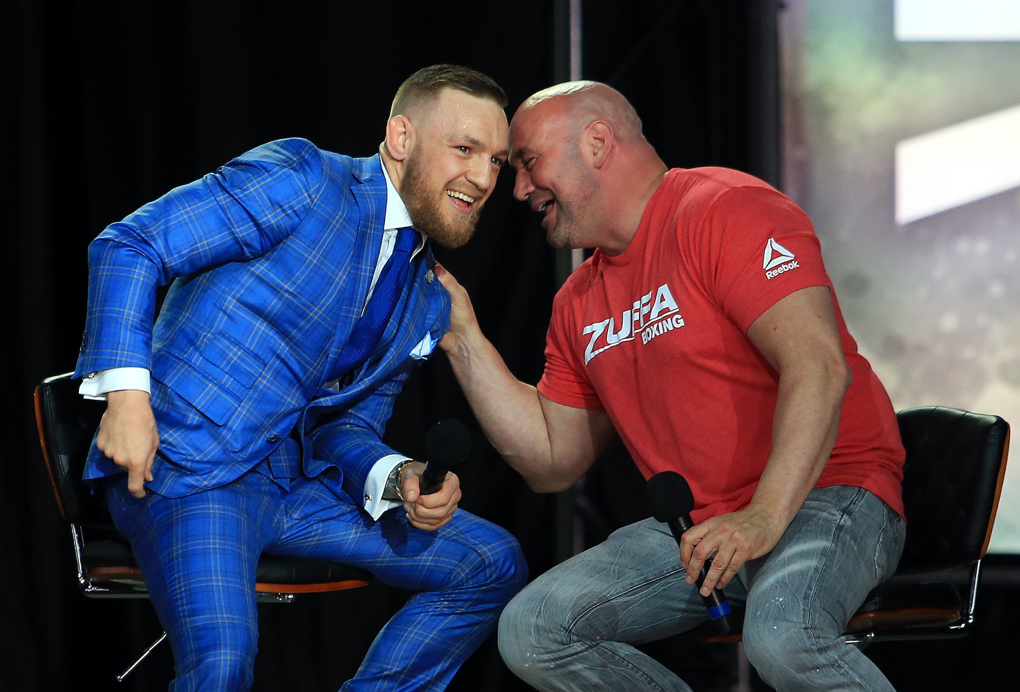 Conor McGregor and Dana White talk during a pre-fight promotional event.