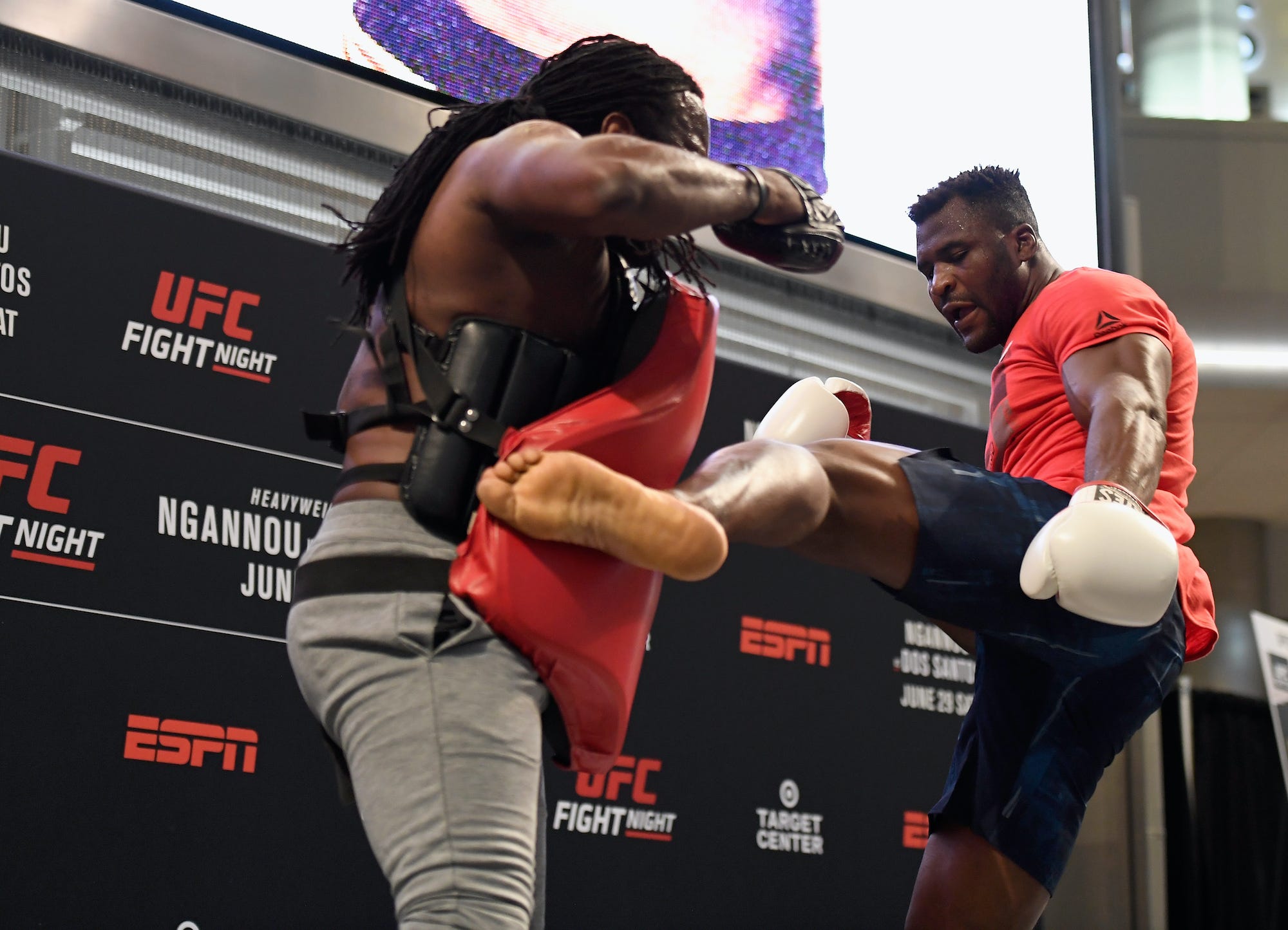 Francis Ngannou throws a kick at one of his MMA coaches.