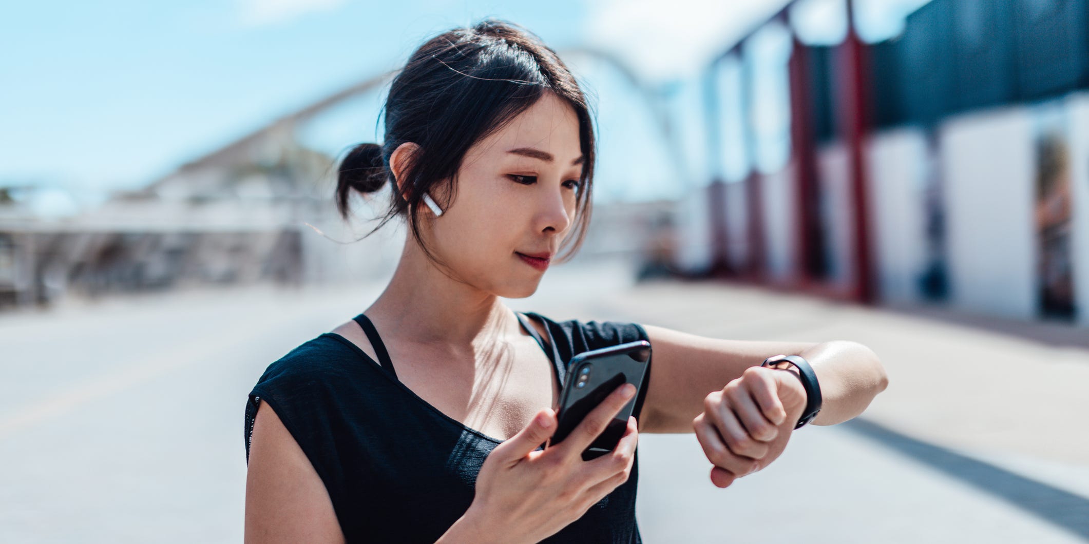 A woman about to exercise checks her phone app.