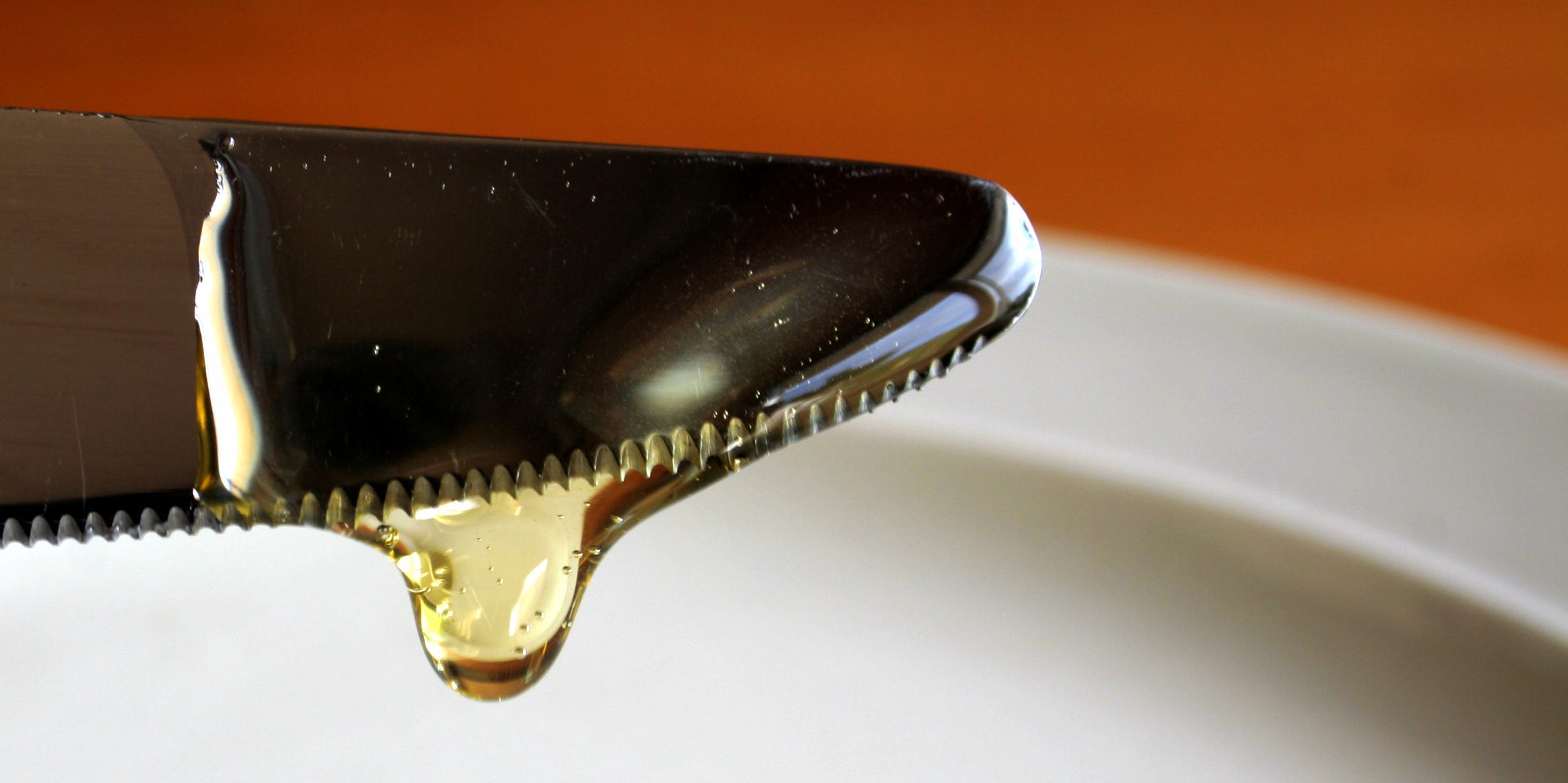 Corn syrup dripping from a knife.