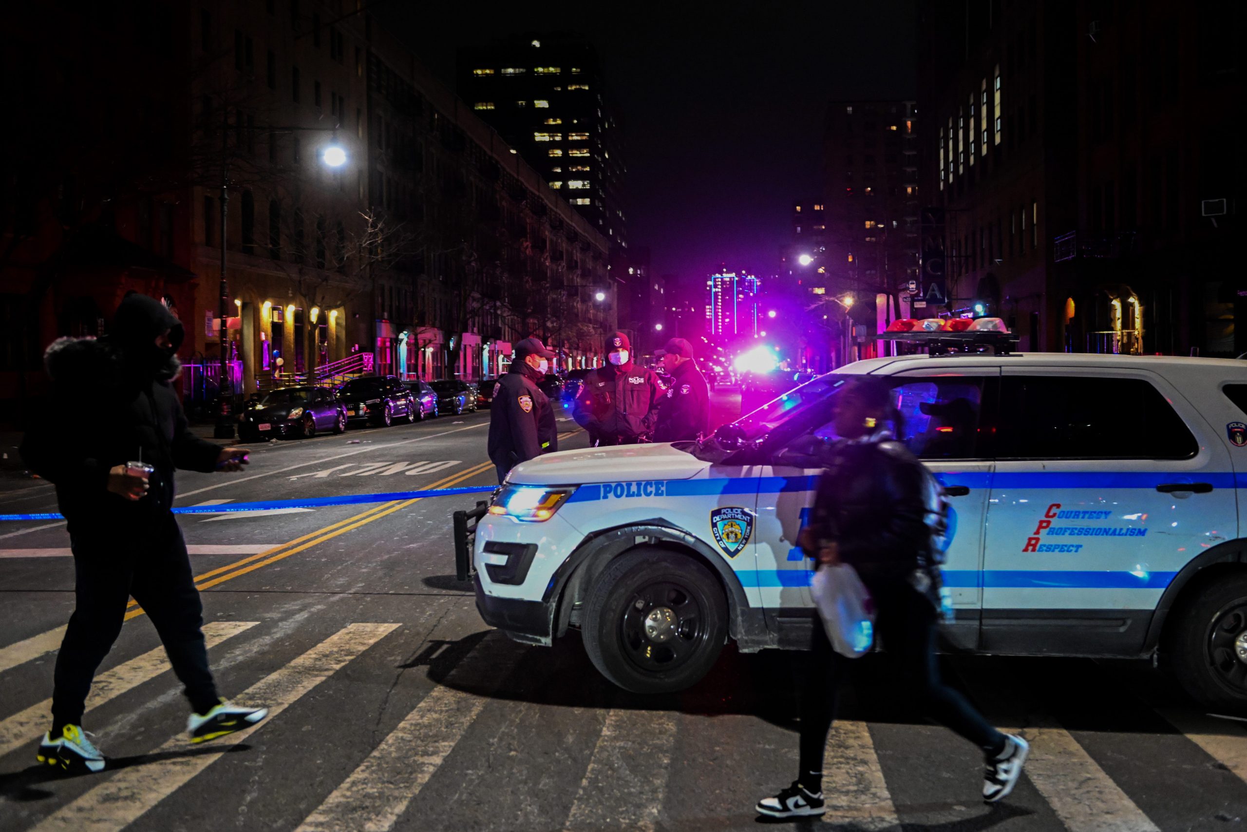 Police officers lock down the scene after two NYPD officers were shot in Harlem on January 21, 2022 in New York City.