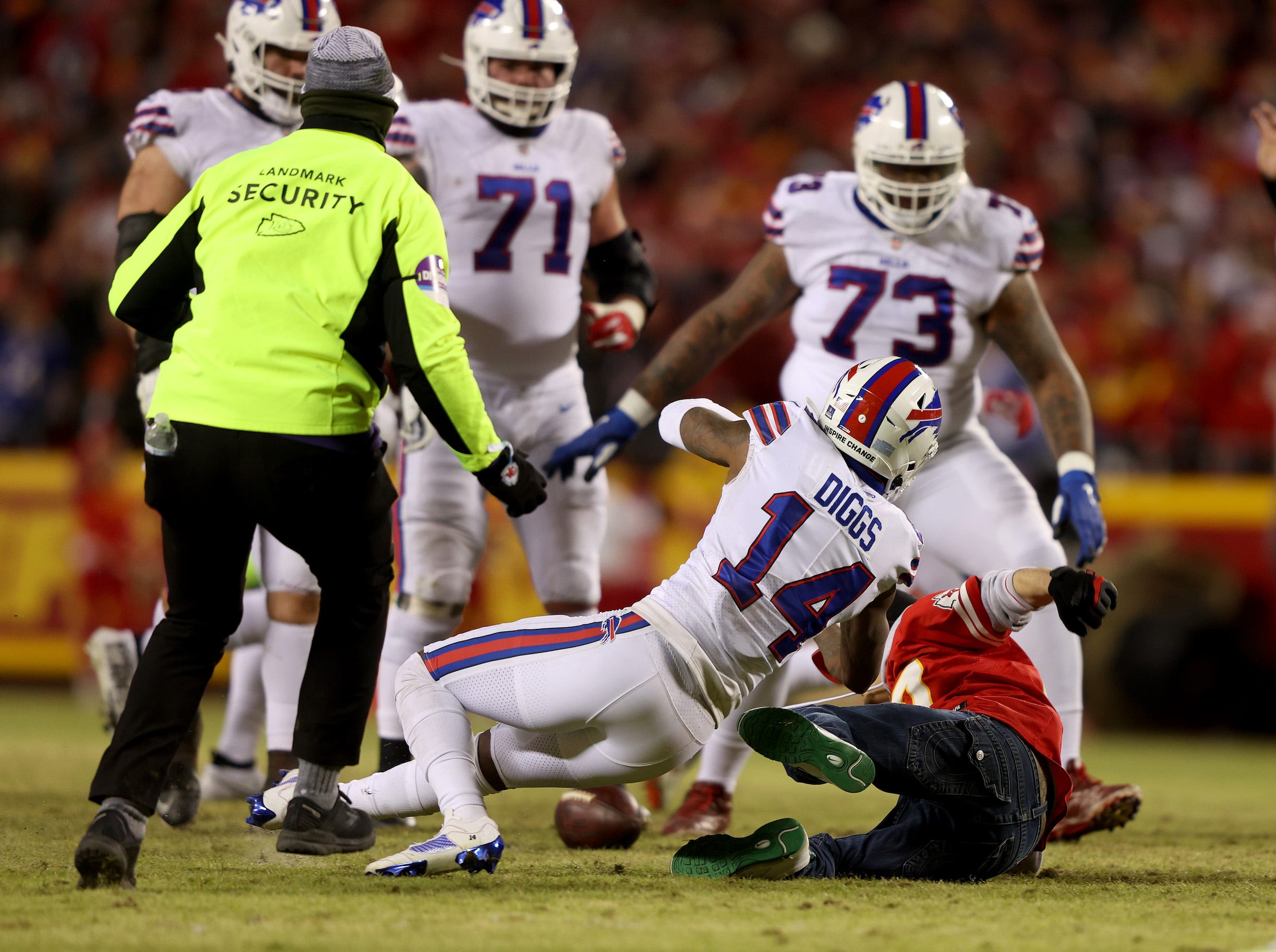 Stefon Diggs tackles a fan on the field during the Bills-Chiefs game.