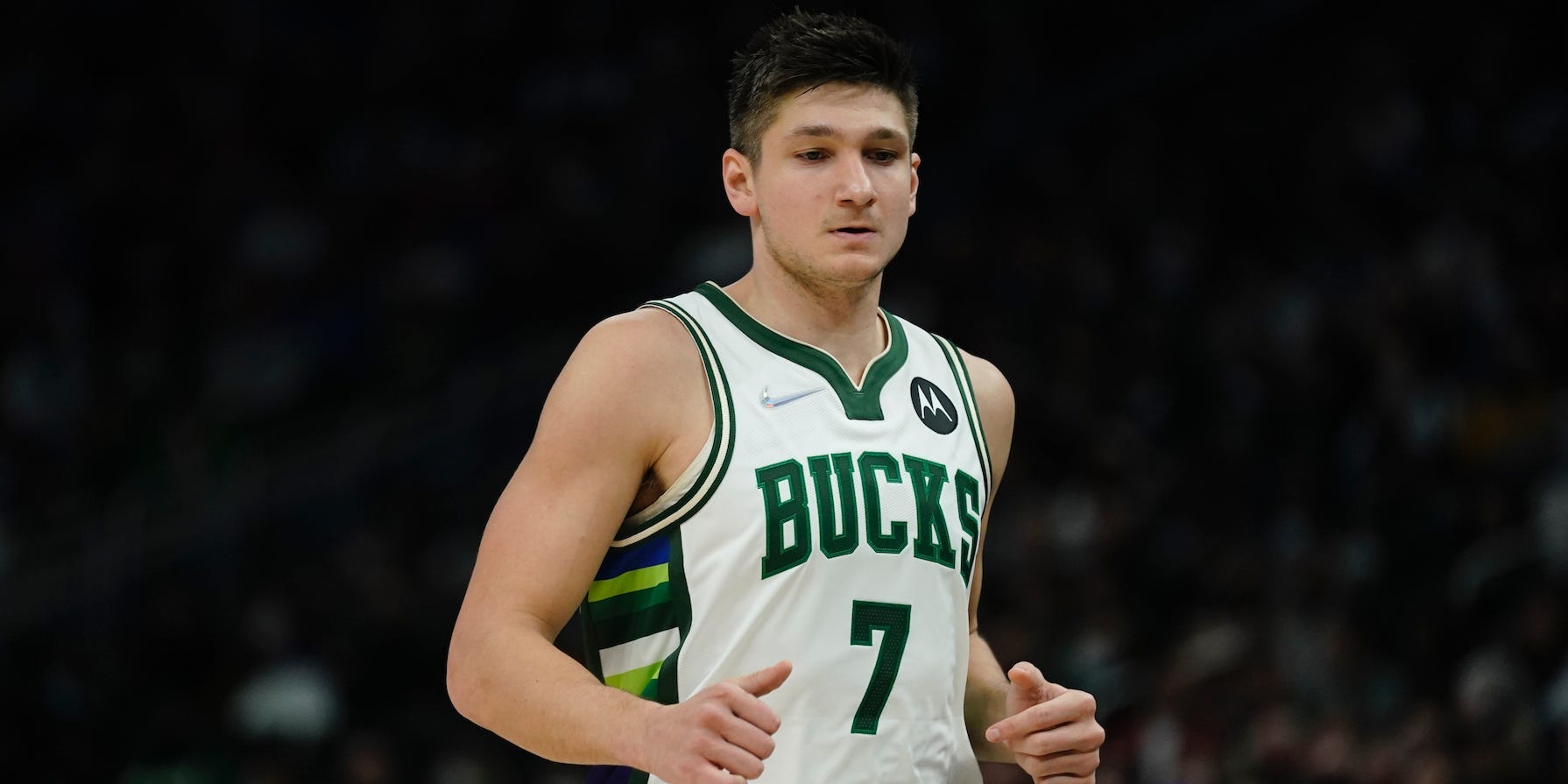 Grayson Allen looks down while running on the court in 2022.