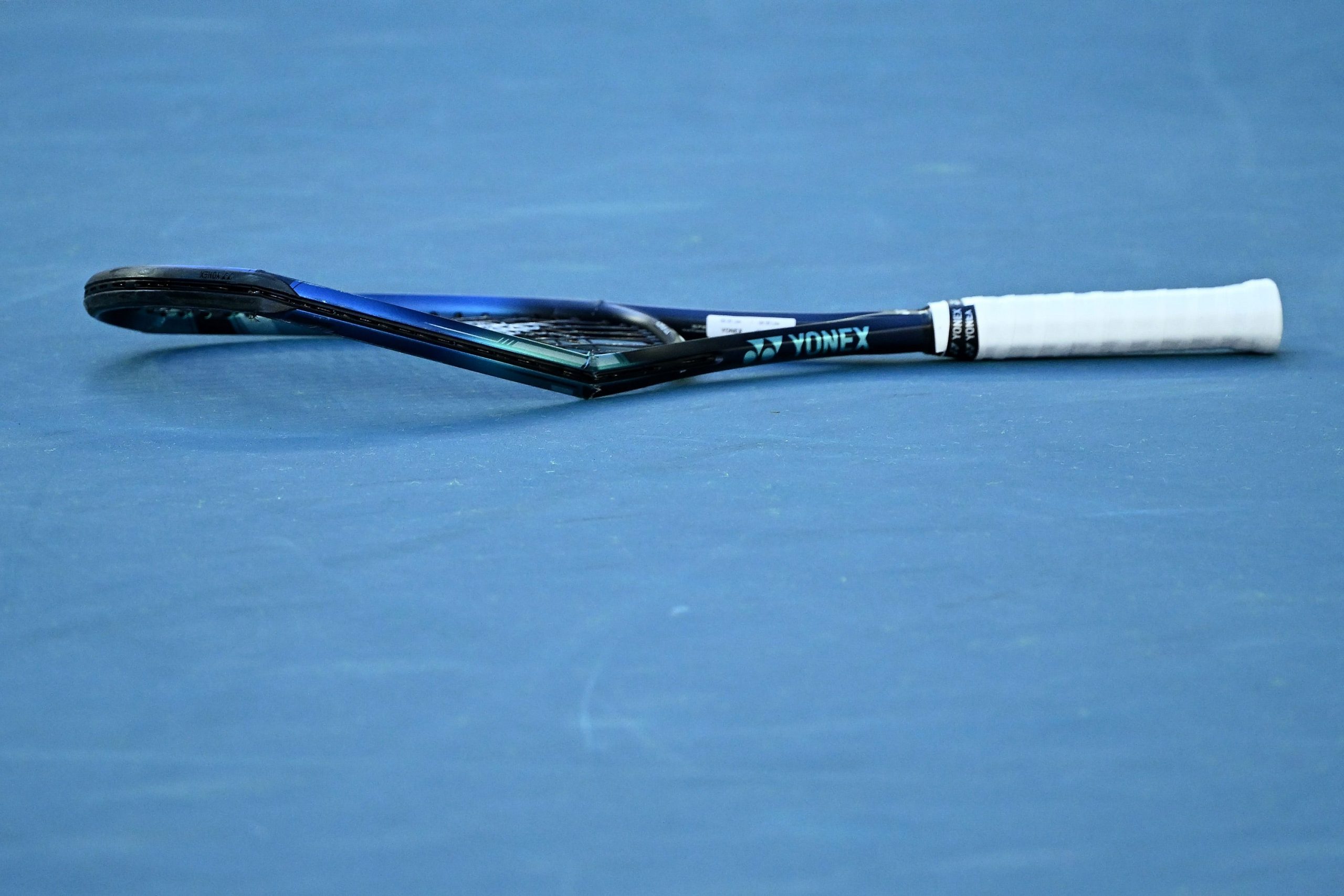 Denis Shapovalov's racquet lies smashed on the court after an outburst following his defeat to Rafael Nadal.