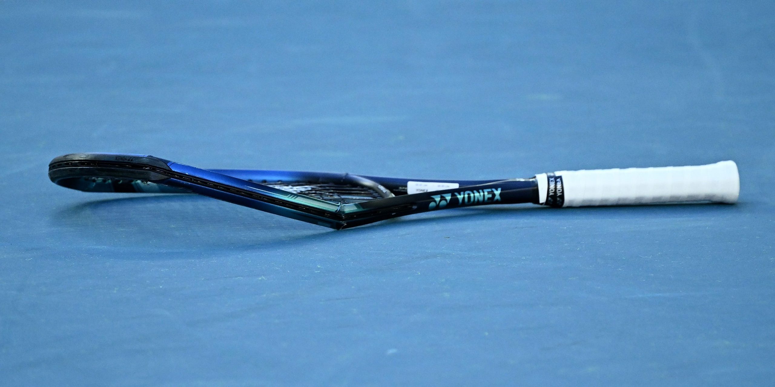 Denis Shapovalov's racquet lies smashed on the court after an outburst following his defeat to Rafael Nadal.