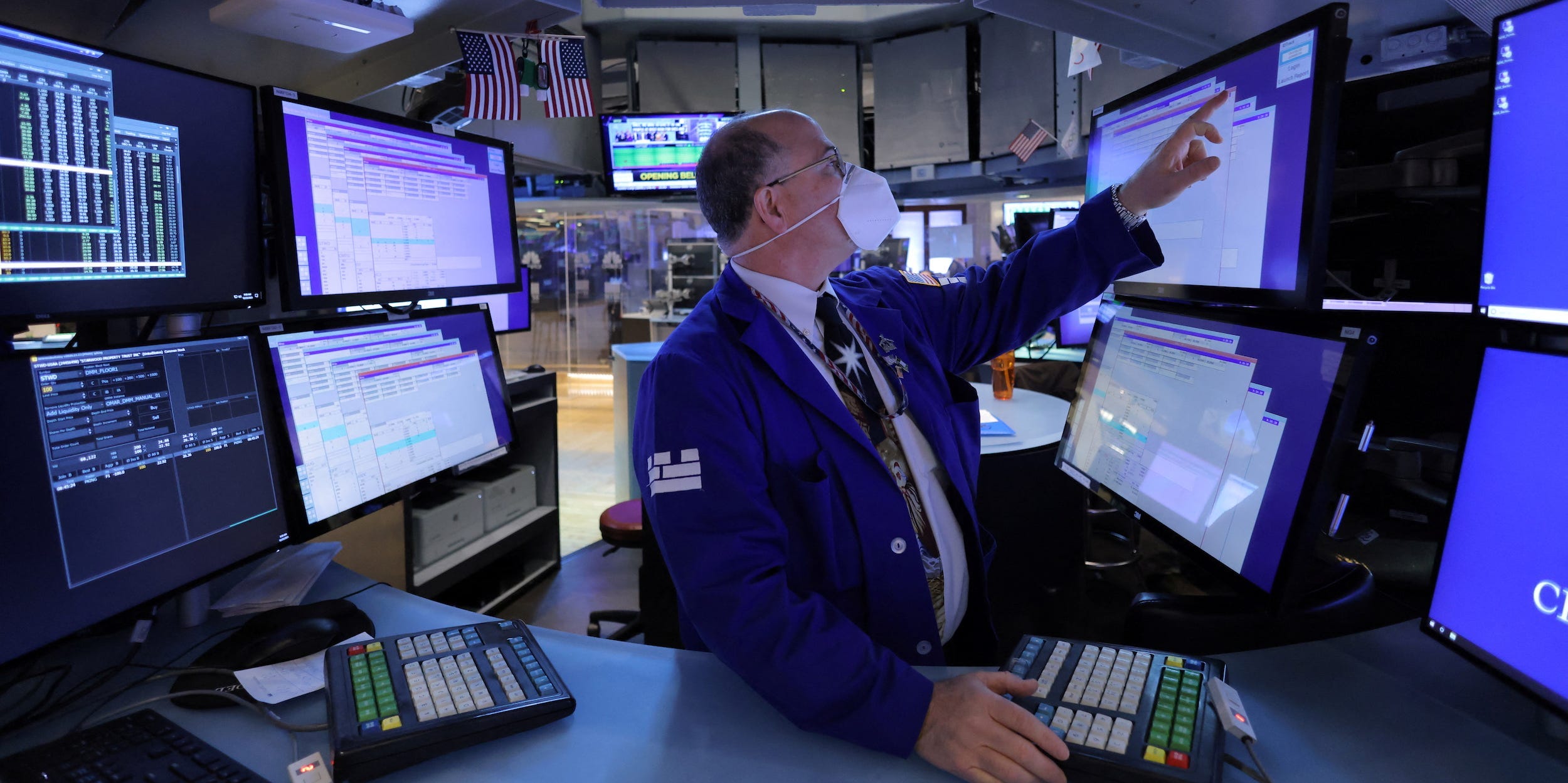 Trader points at screen at NYSE