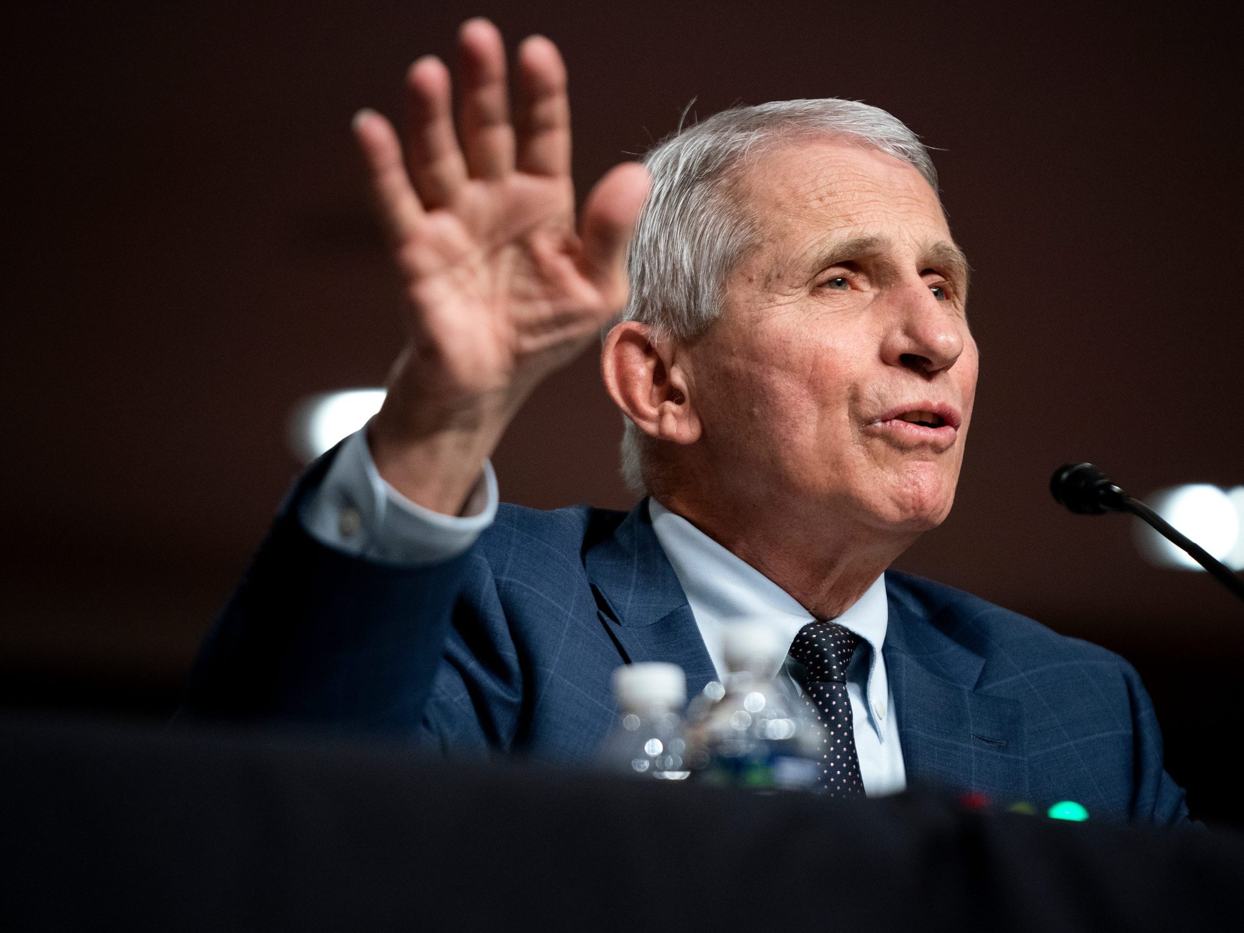 Dr. Anthony Fauci raises right hand as he testifies at a Senate Health, Education, Labor, and Pensions Committee hearing on Capitol Hill.