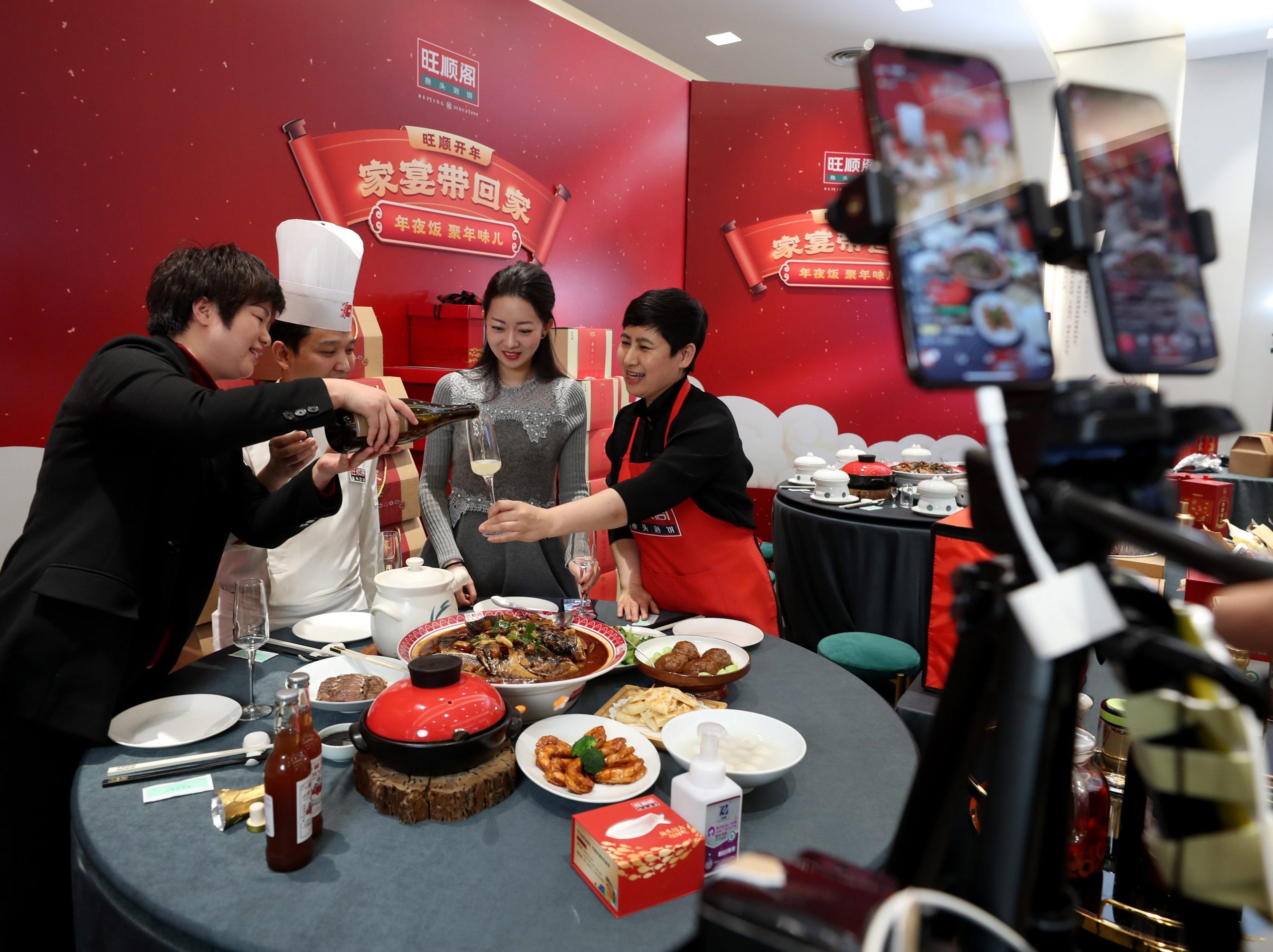 Employees sell dishes for Lunar New Year's Eve dinner via video livestream at a restaurant on January 28, 2021 in Beijing, China
