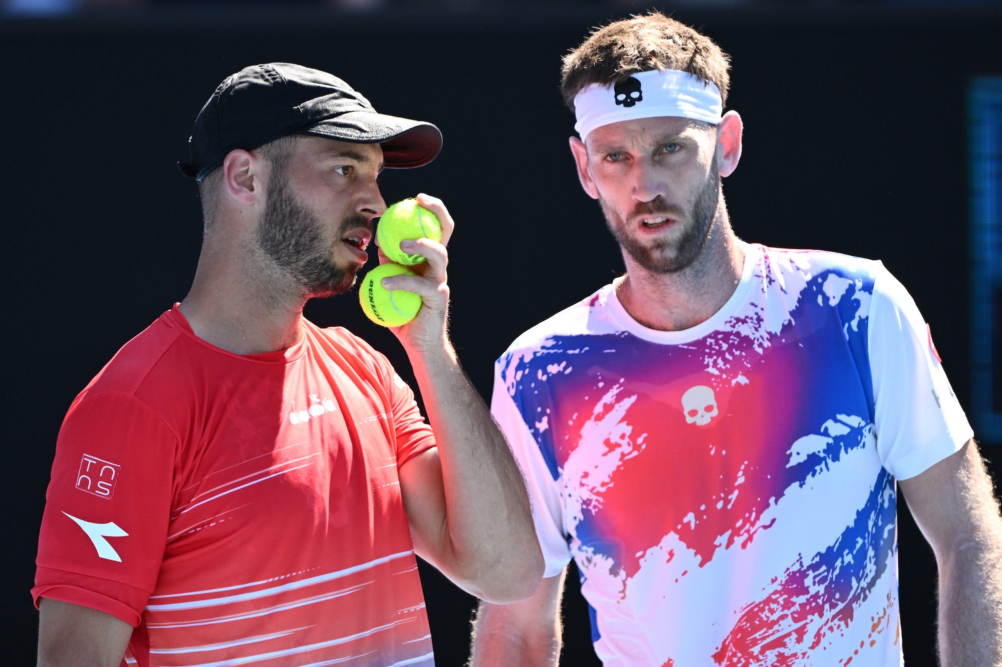 Tim Puetz (L) of Germany and Michael Venus of New Zealand talk tactics in their Men's Doubles Quarterfinals match against Thanasi Kokkinakis of Australia and Nick Kyrgios of Australia during day nine of the 2022 Australian Open at Melbourne Park