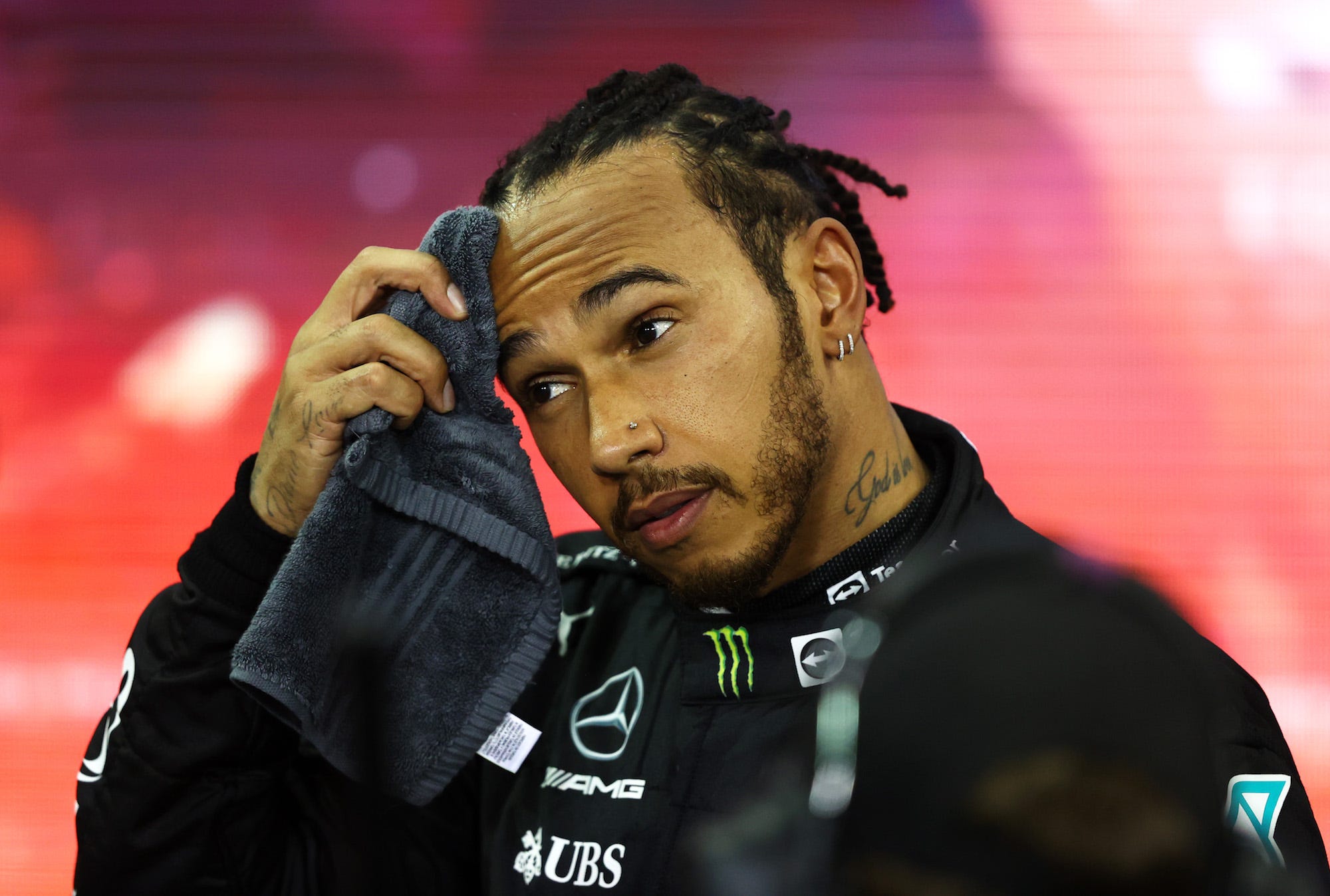 Second placed and championship runner up Lewis Hamilton of Great Britain and Mercedes GP looks dejected in parc ferme during the F1 Grand Prix of Abu Dhabi at Yas Marina Circuit on December