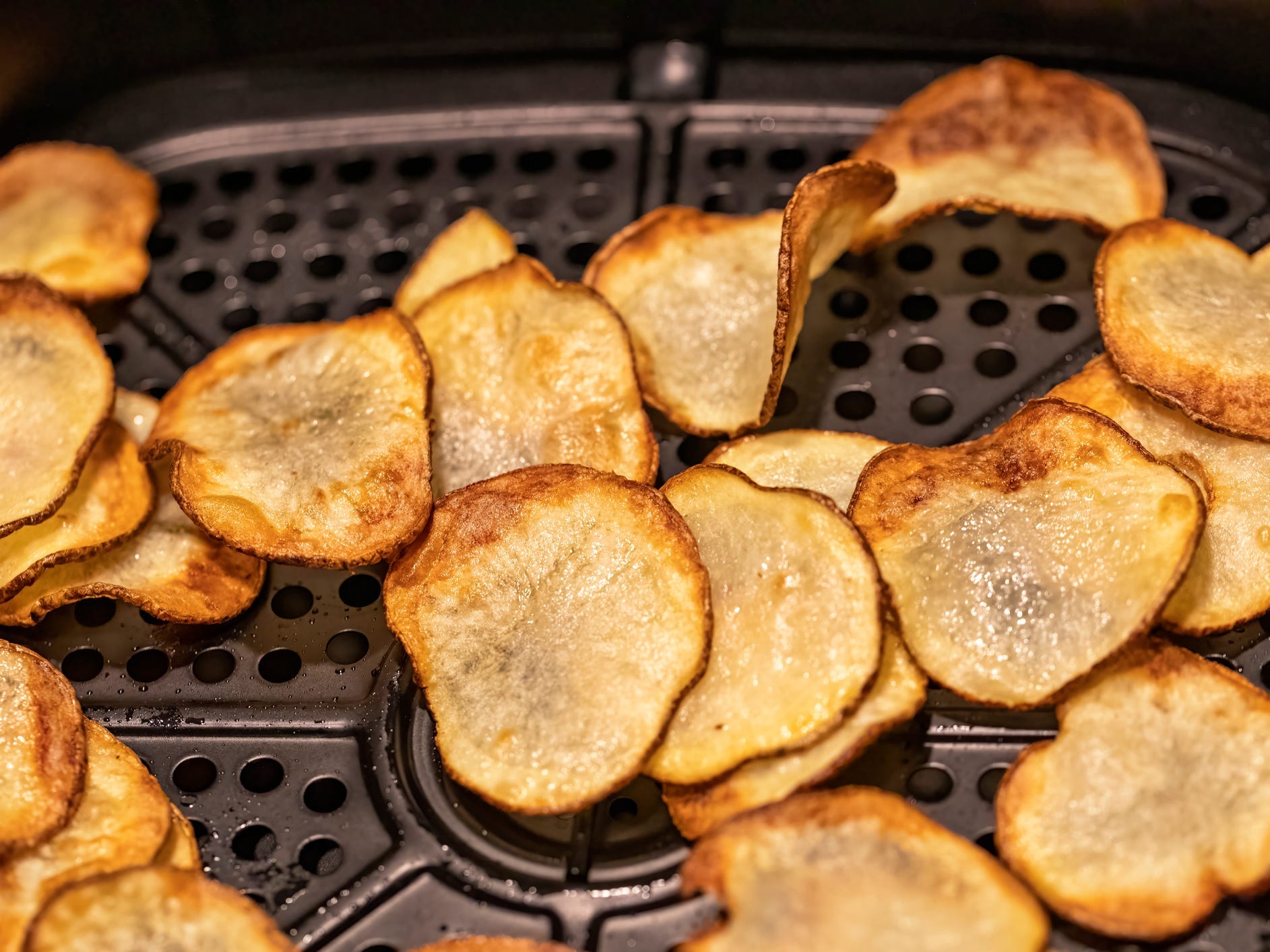 Potato chips in an air fryer basket