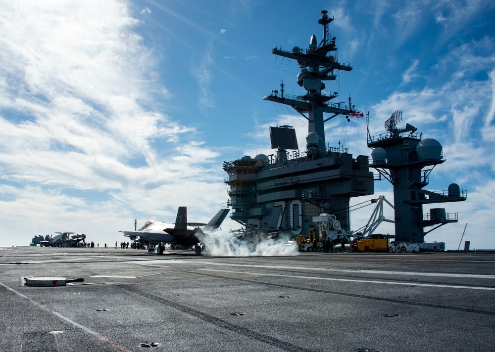 An F-35C Lightning II from Strike Fighter Squadron (VFA) 147 lands on the flight deck of Nimitz-class nuclear aircraft carrier USS Carl Vinson (CVN 70)