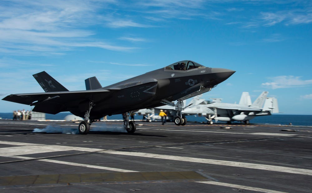 An F-35C Lightning II from Strike Fighter Squadron (VFA) 147 lands on the flight deck of Nimitz-class nuclear aircraft carrier USS Carl Vinson (CVN 70)