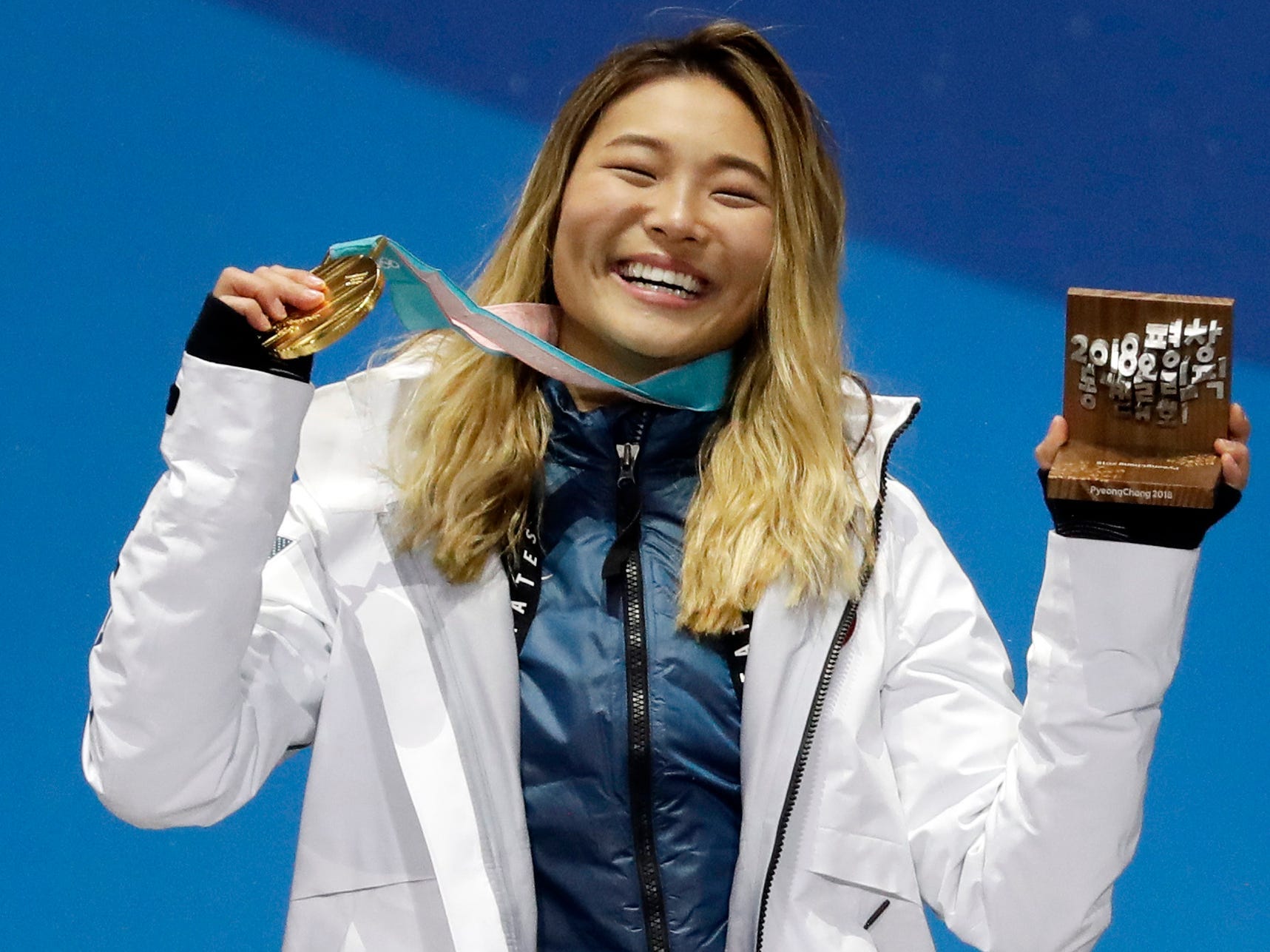 Chloe Kim poses with her Olympic gold medal from the 2018 games.