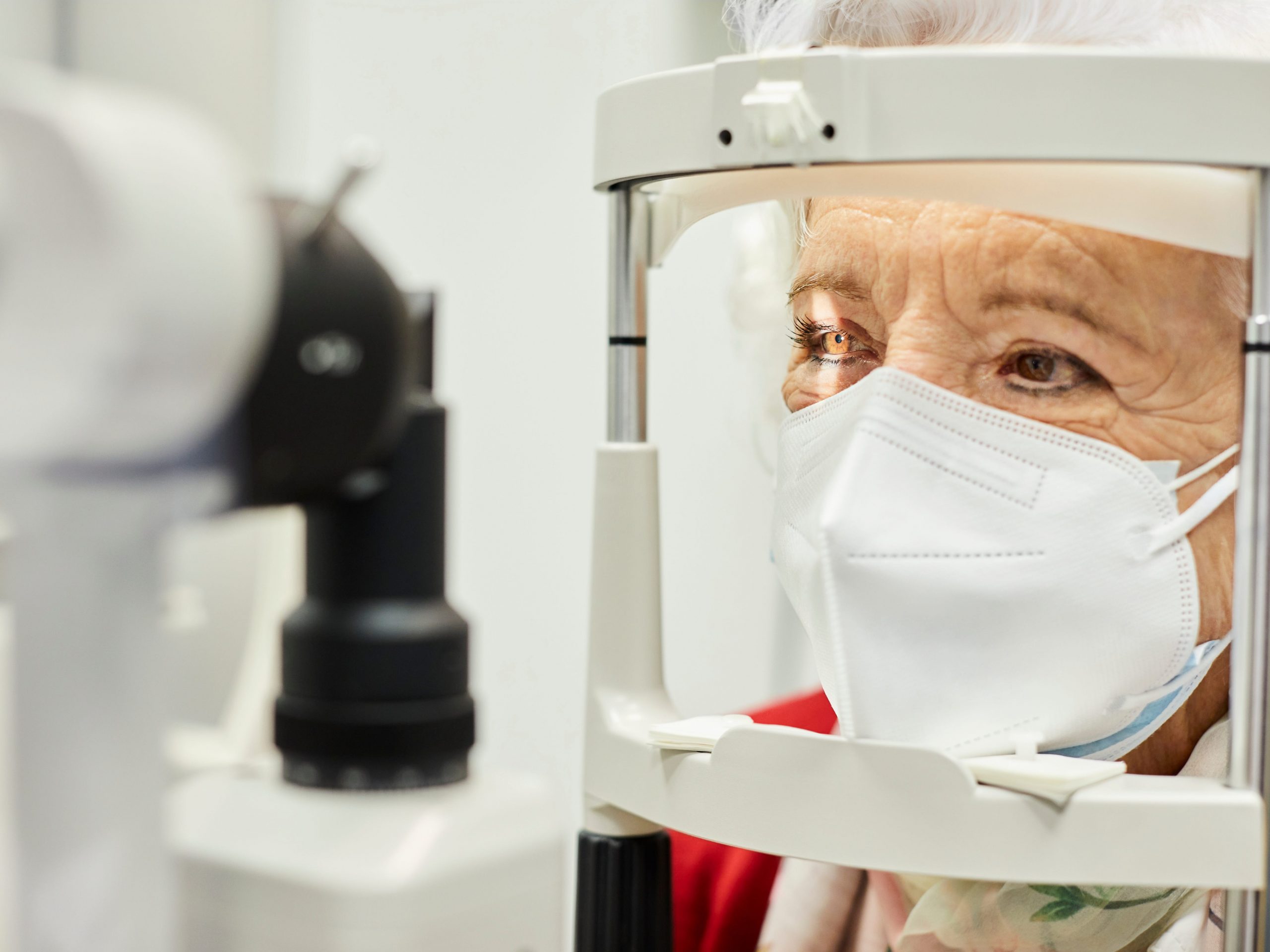 Women with mask gets eye test.
