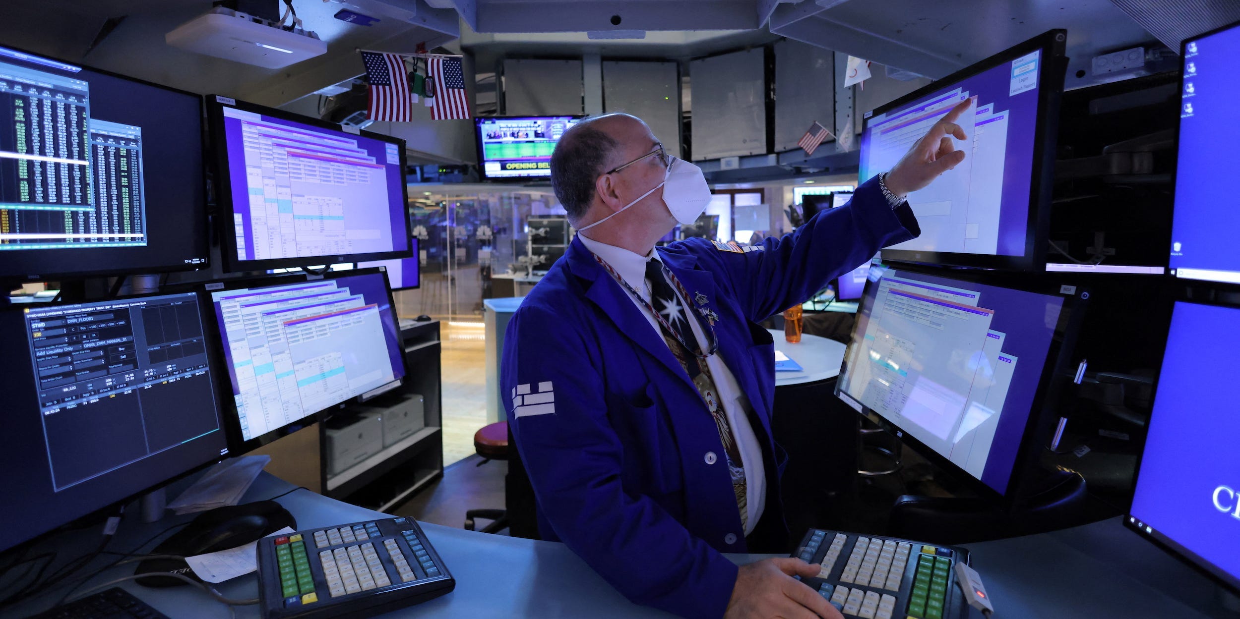 Trader points at screen at NYSE