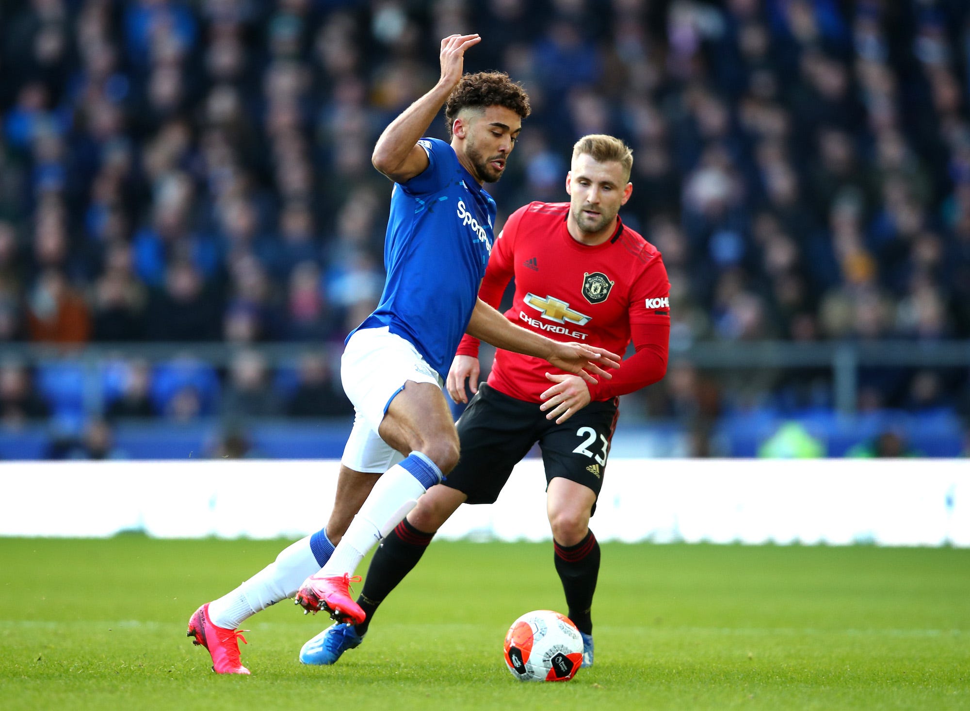 Dominic Calvert-Lewin of Everton battles for possession with Luke Shaw of Manchester United during the Premier League match between Everton FC and Manchester United at Goodison Park