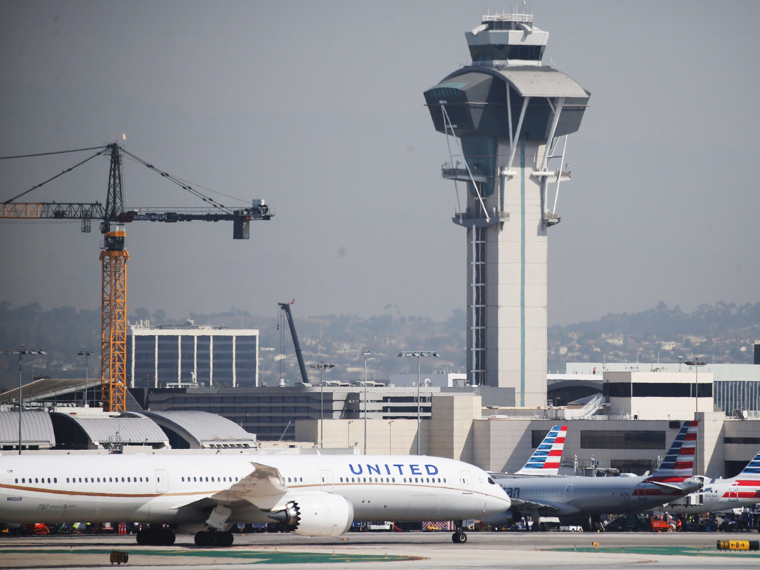 A United Airlines plane taxis past American Airlines planes on the tarmac at Los Angeles International Airport (LAX) on October 1, 2020 in Los Angeles, California.