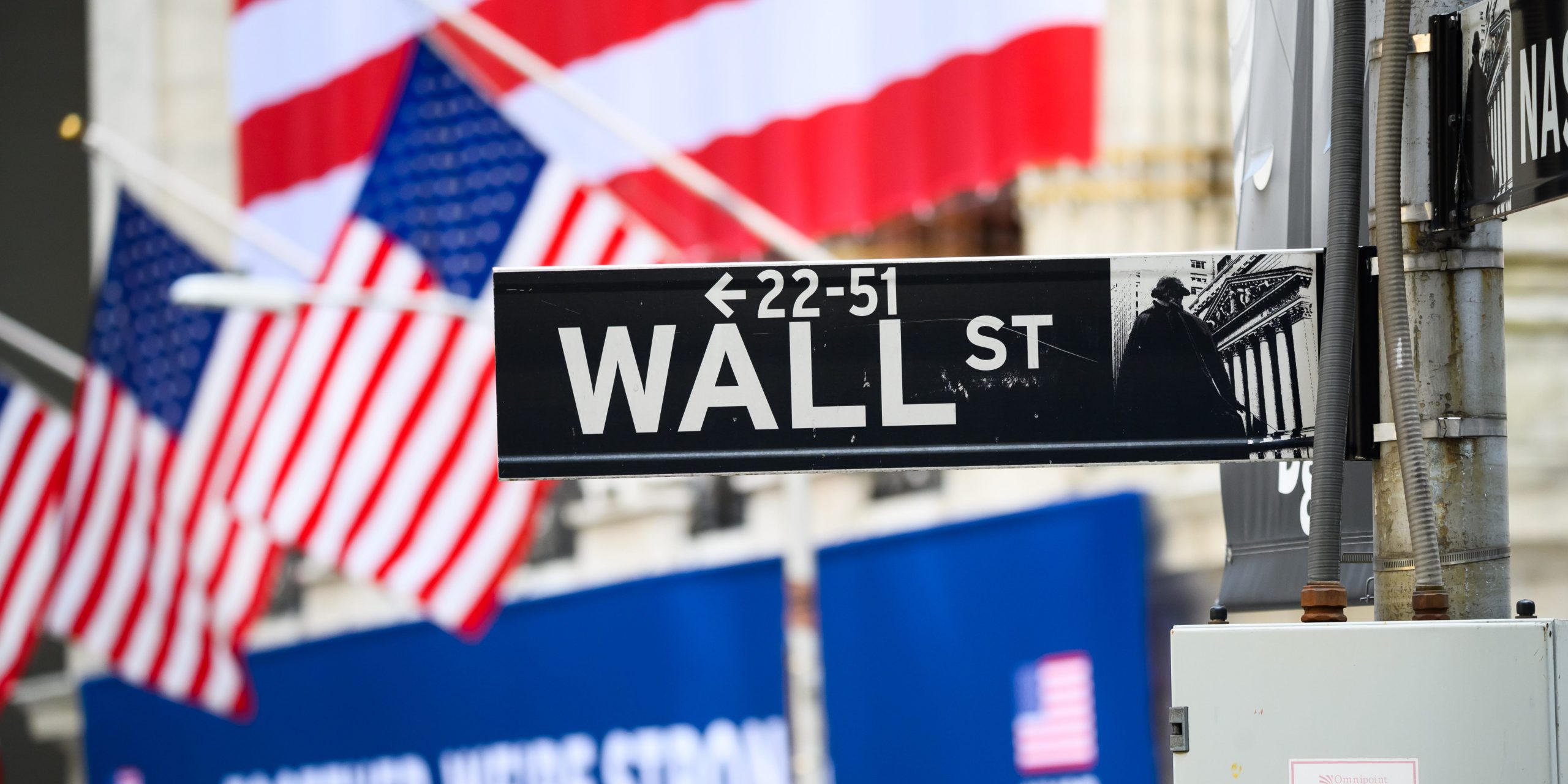 A view of the Wall Street street sign with the New York Stock Exchange during the coronavirus pandemic on May 25, 2020 in New York City.